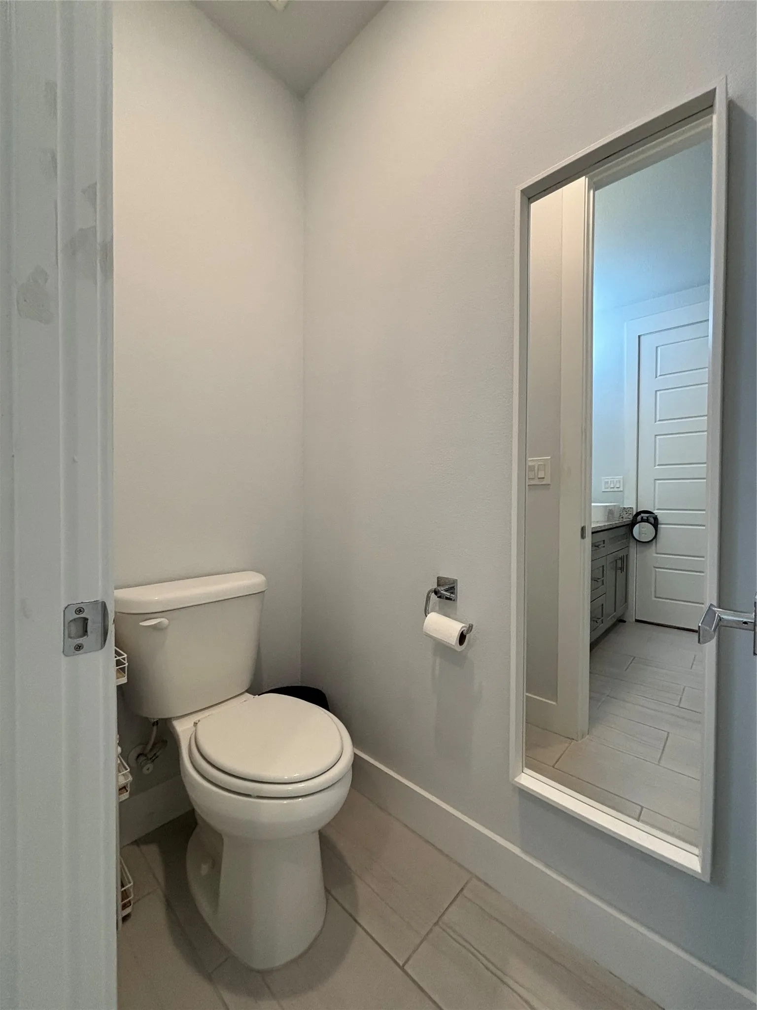 White toilet with chrome toilet paper holder