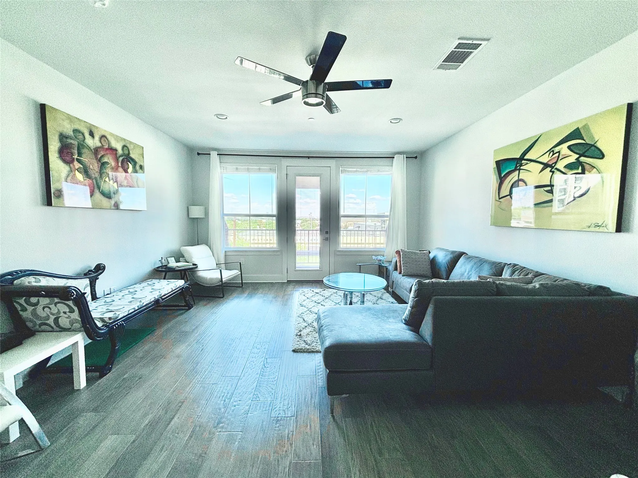 Wood-finish flooring throughout, recessed lighting, and a ceiling fan