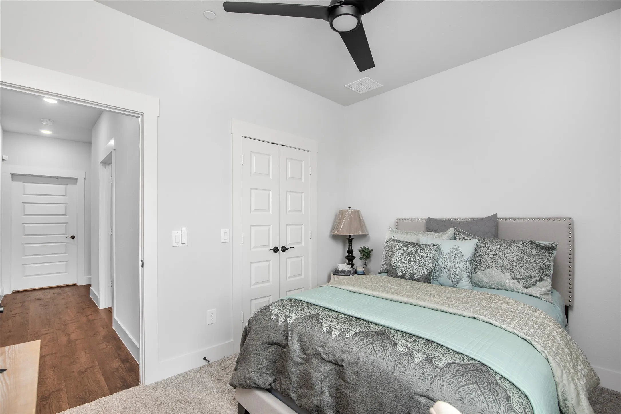 Recessed lighting, wood-finish flooring, and a modern ceiling fan with integrated lighting