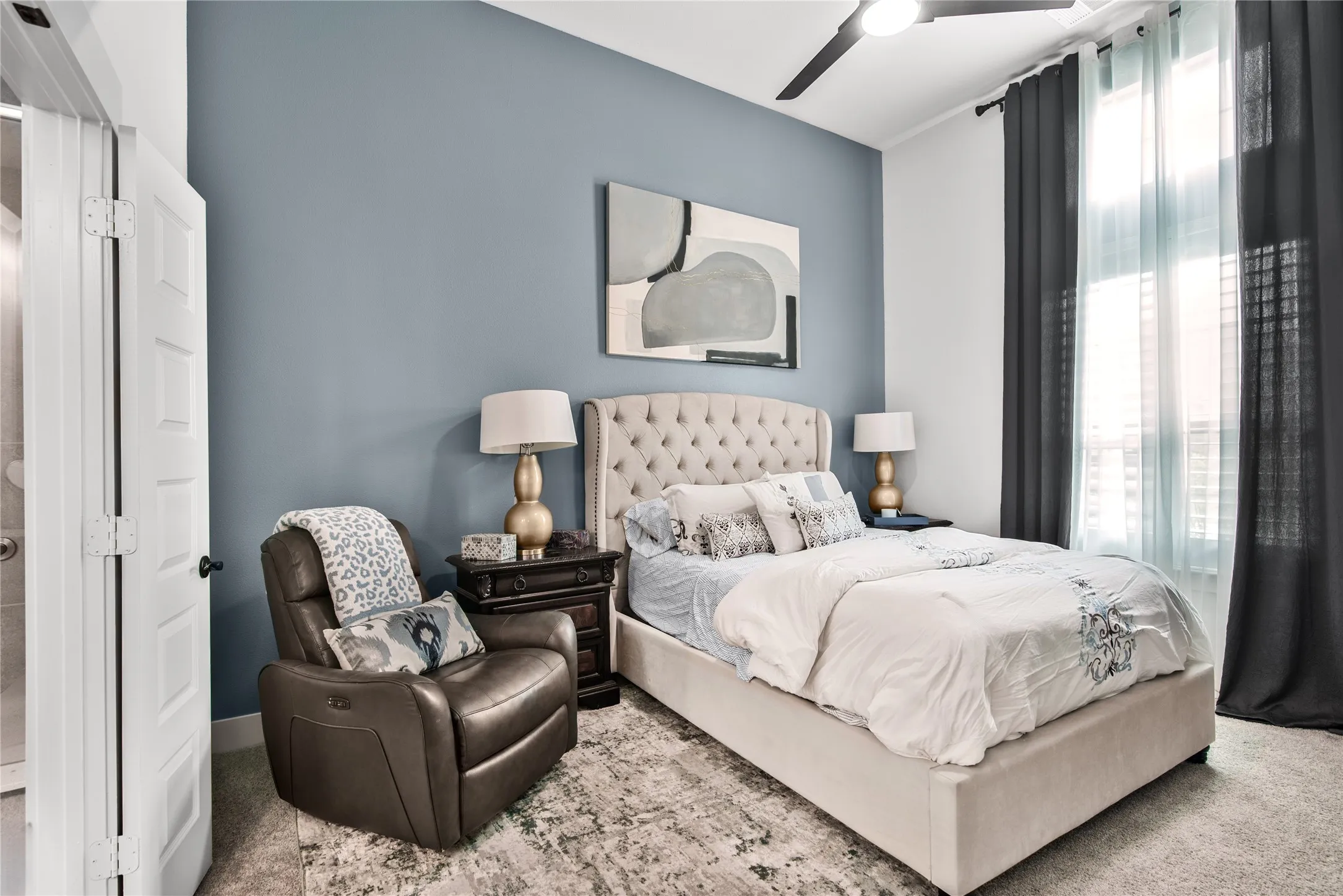 Vaulted ceiling, ceiling fan, accent wall, window with blinds, and white door