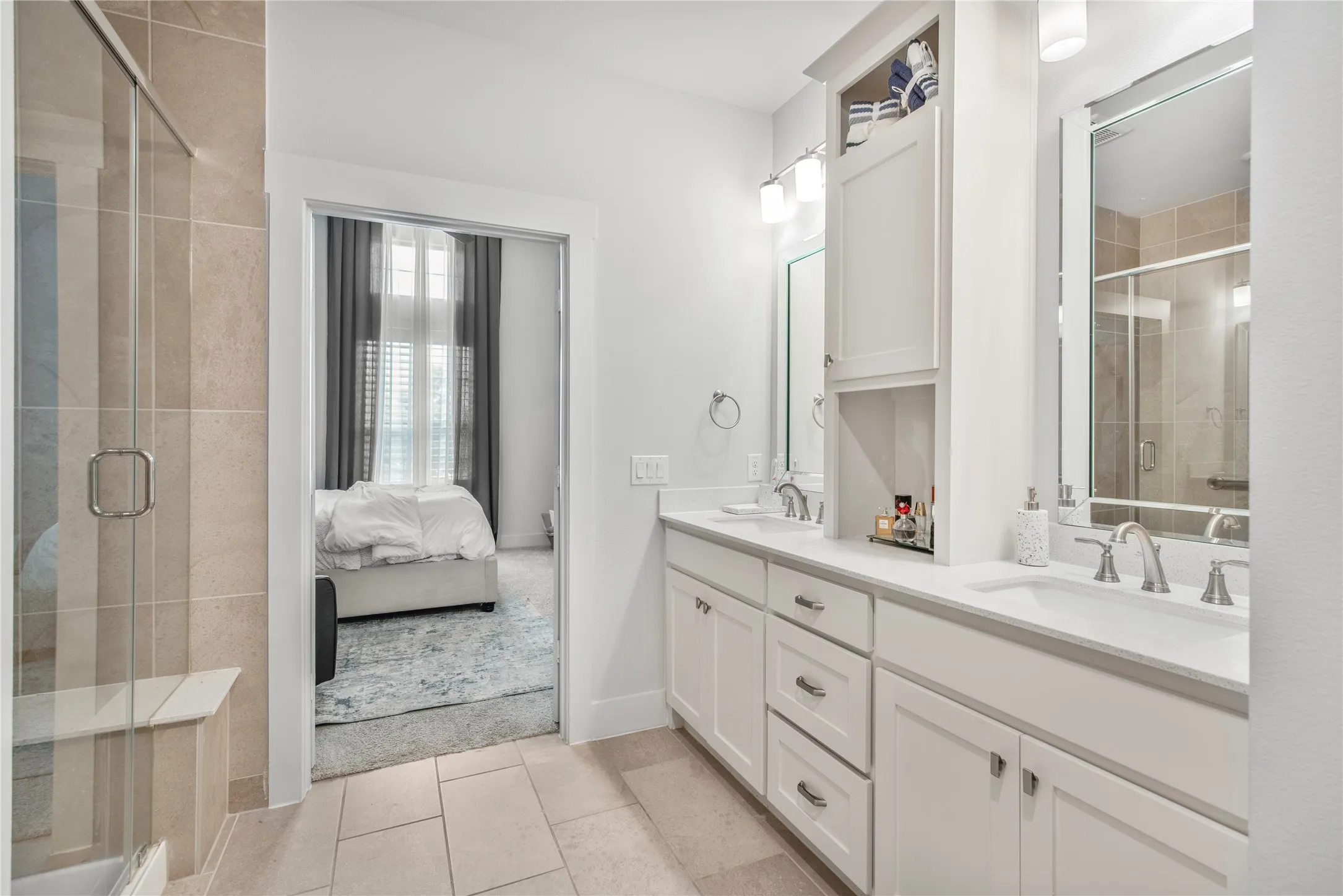 Dual vanity with undermount sinks, white cabinetry, and brushed nickel hardware