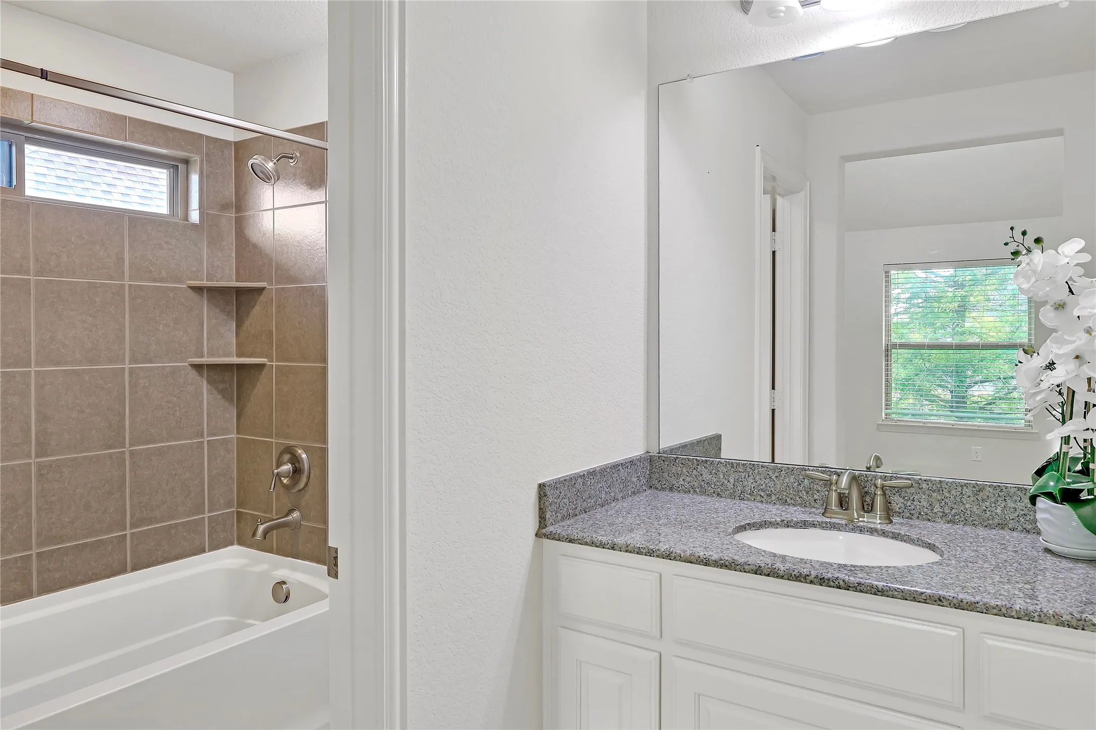 Full bath featuring  shower combination and vanity