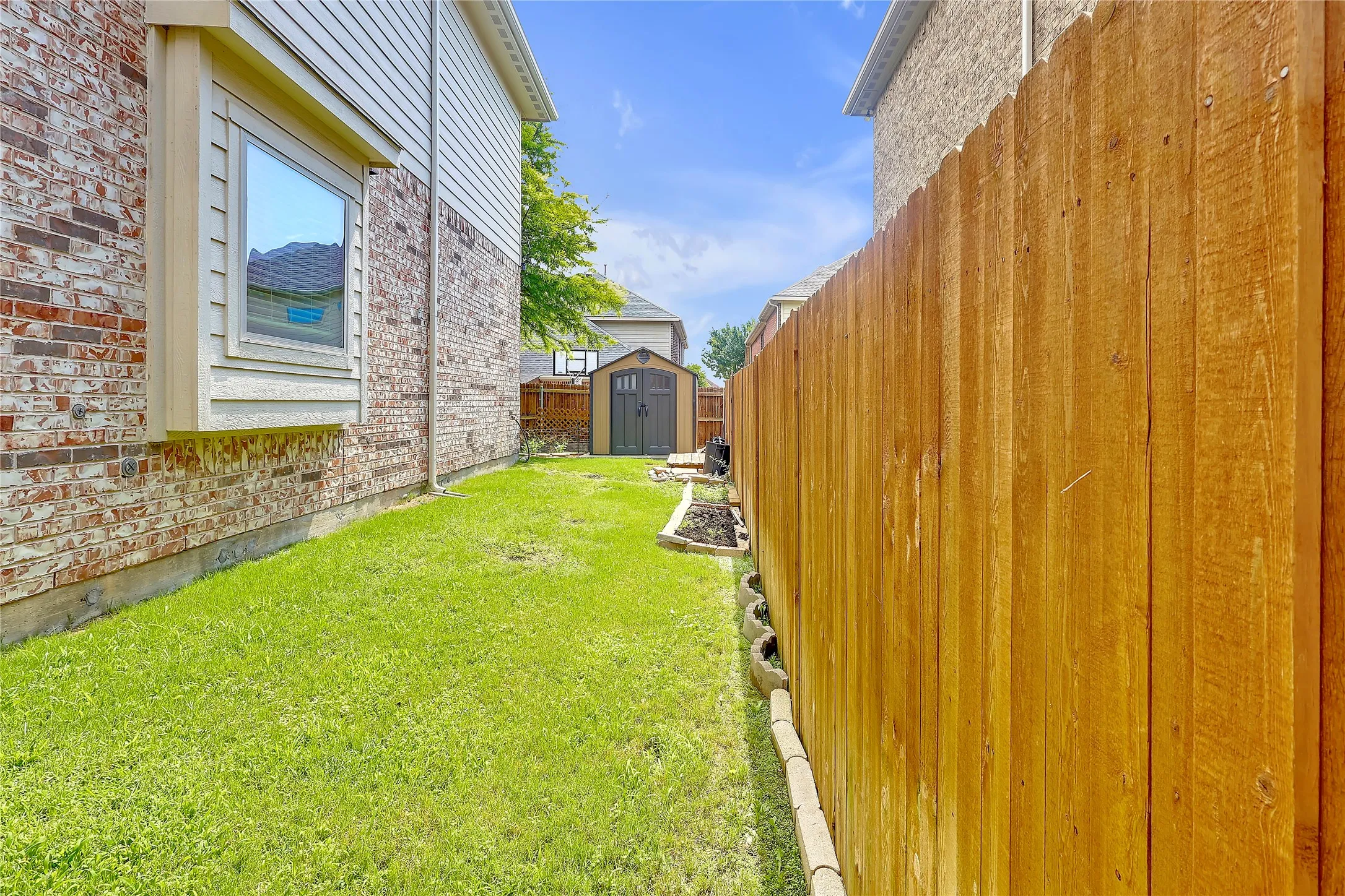View of yard with a storage unit