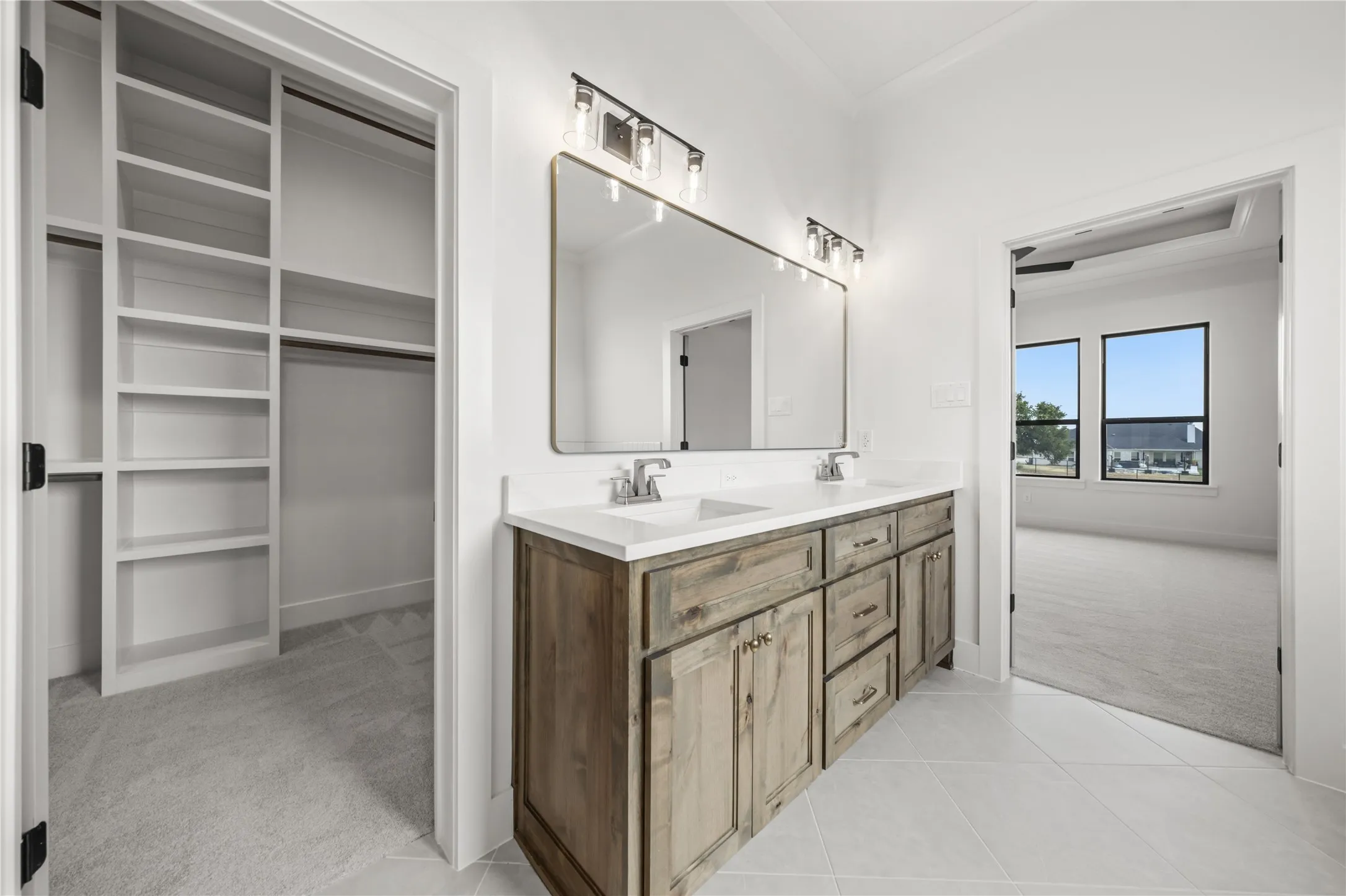 Dual vanity with wood-finish cabinetry and white countertop