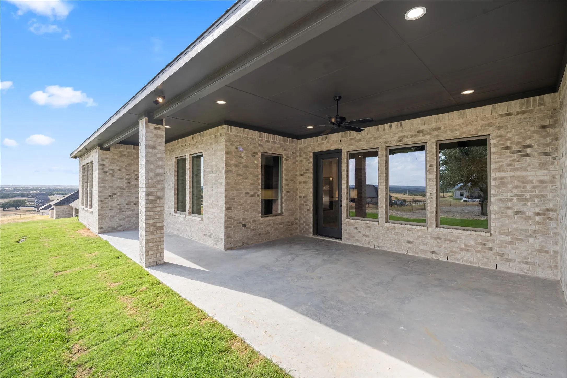Covered patio featuring a ceiling fan, recessed lighting, and multiple windows