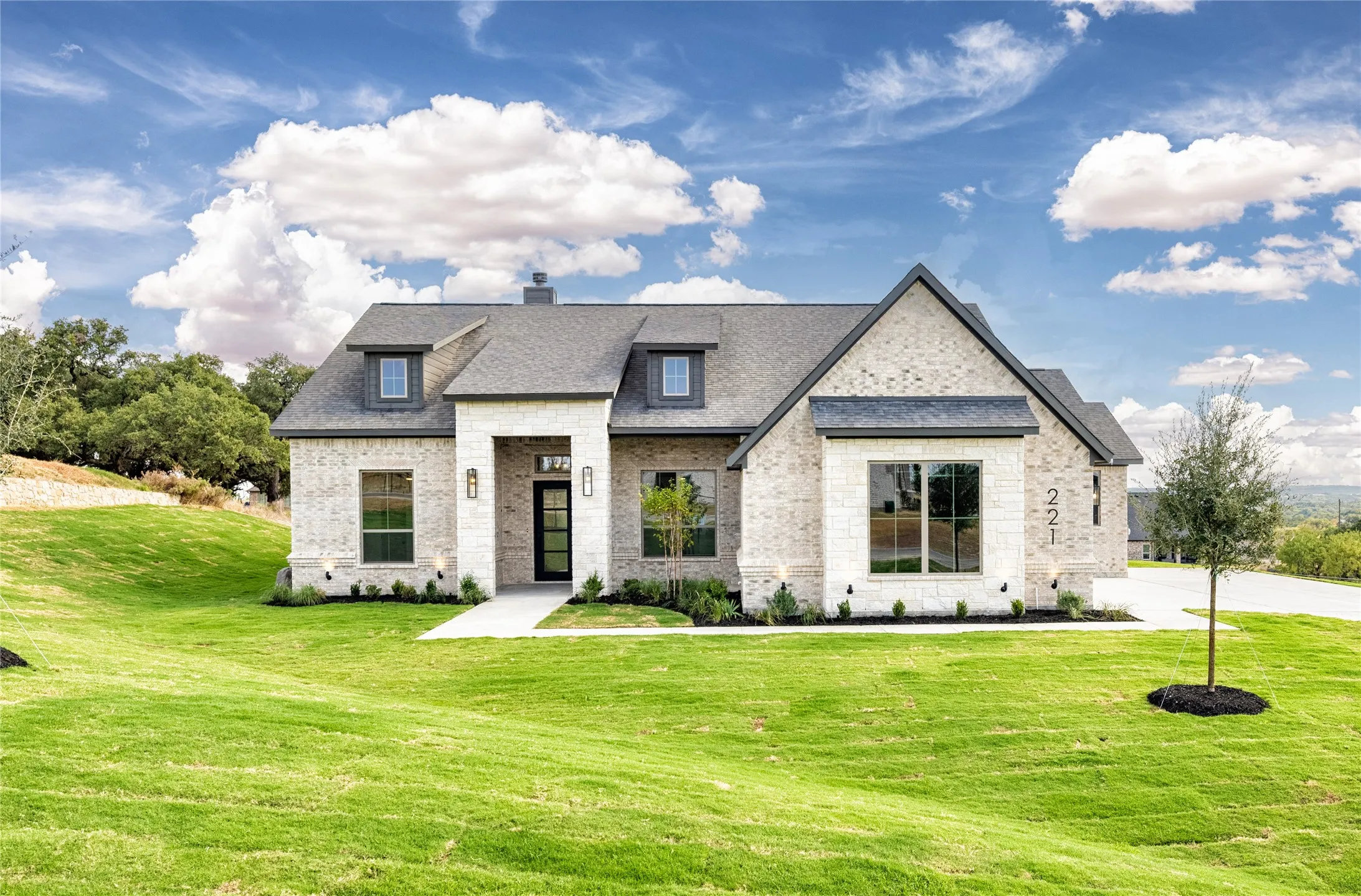 Light brick exterior with dark trim and roof