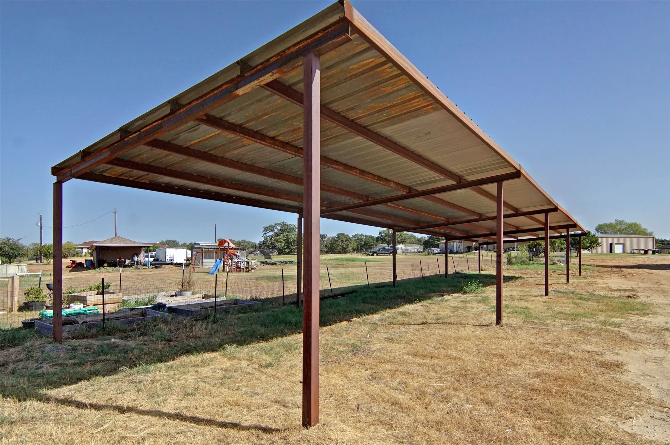 Expansive covered structure with a corrugated metal roof and metal support beams