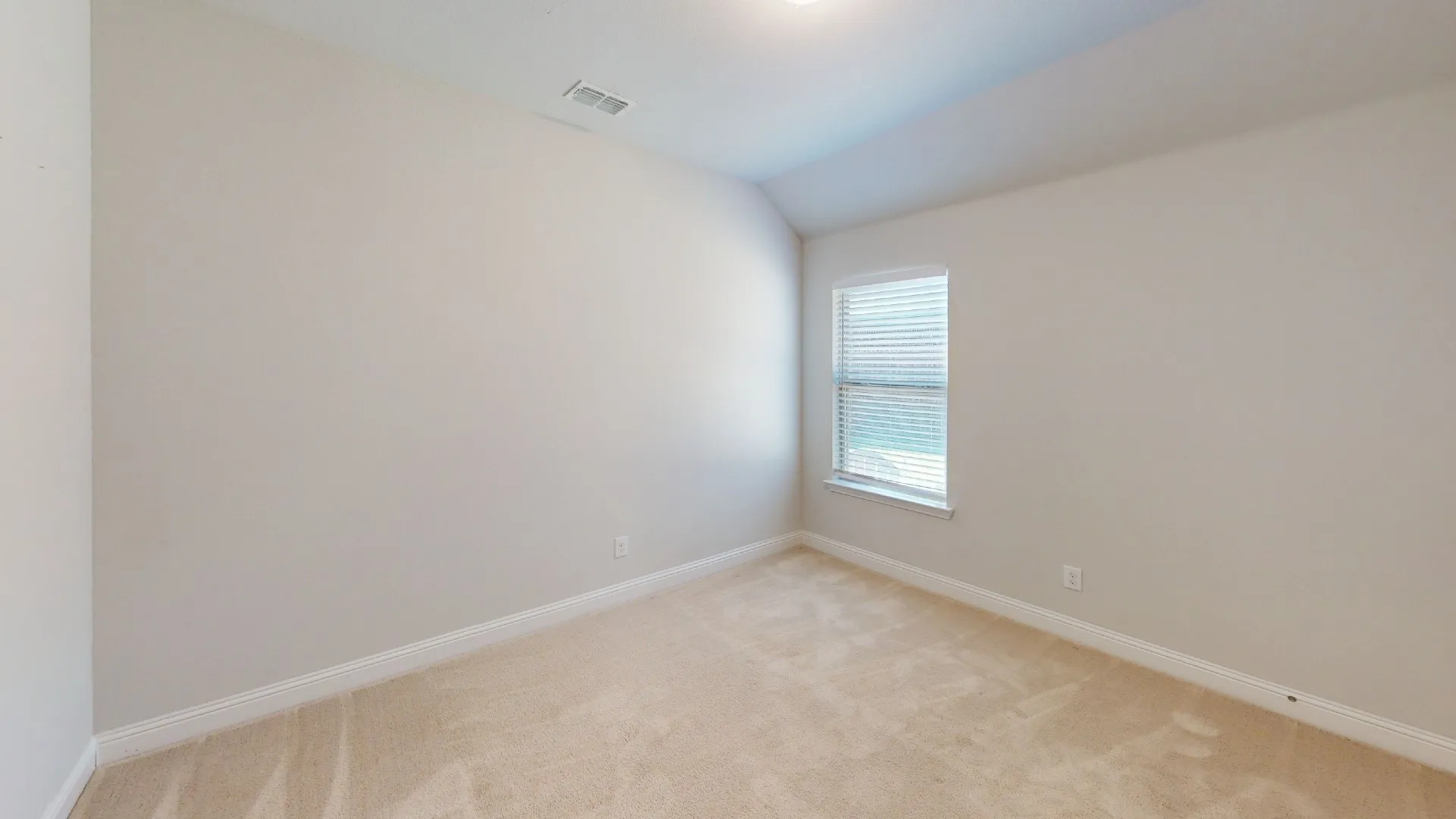 Window with blinds, wall-to-wall carpeting, and recessed ceiling lighting