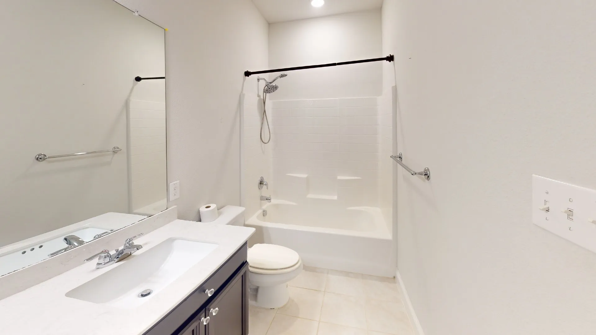 Vanity with an integrated sink, polished chrome faucet, and dark wood-finish cabinetry