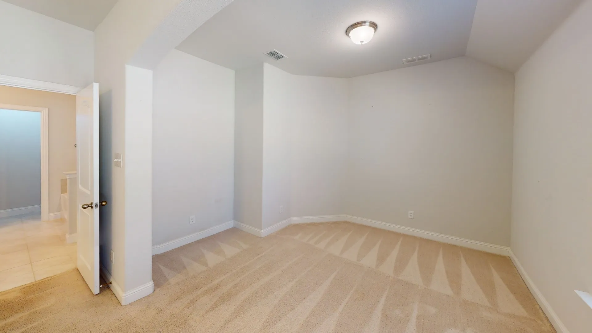 Recessed wall feature, neutral wall tones, neutral carpet, flush mount ceiling light, white door with brushed nickel hardware
