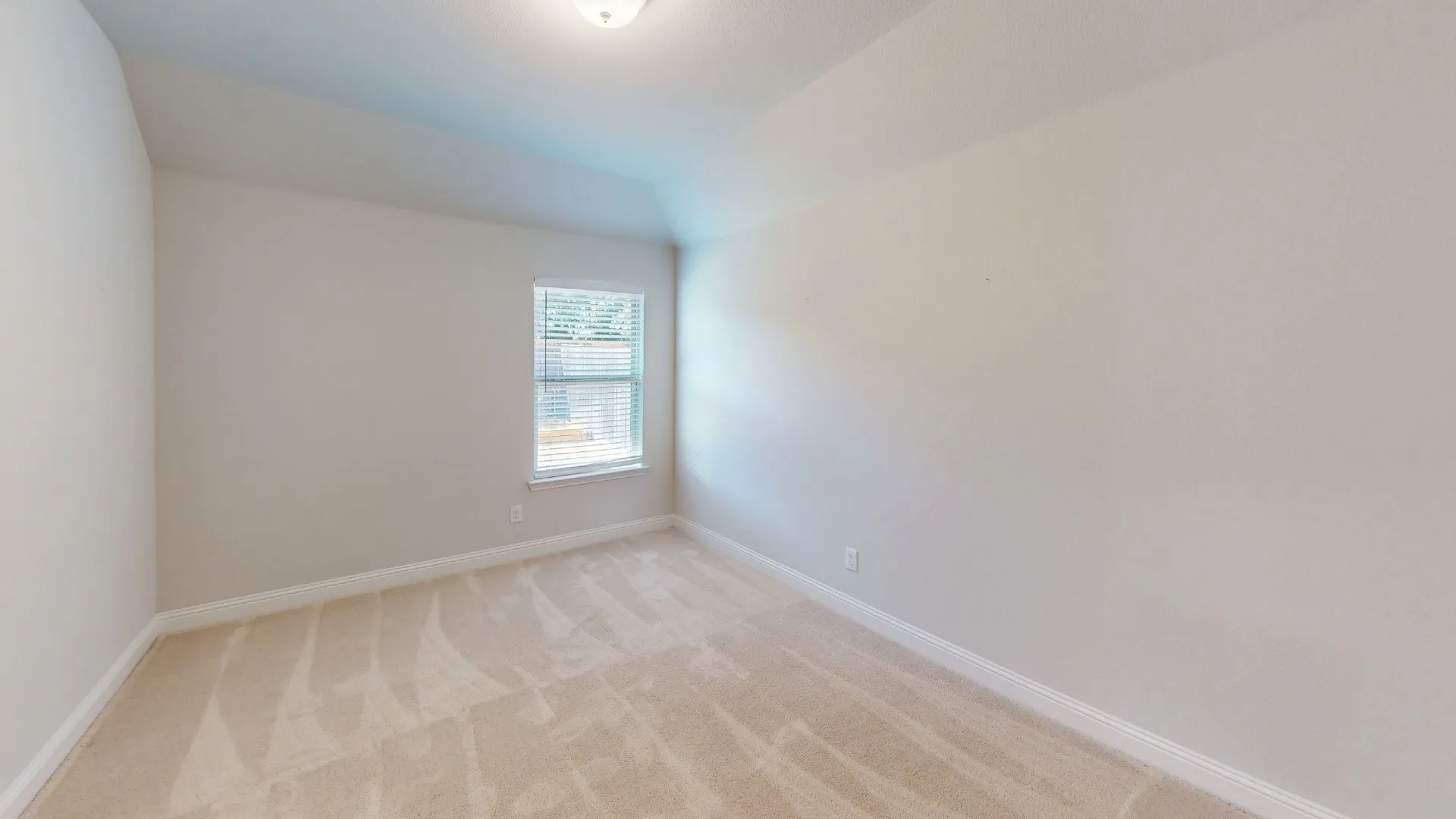 Vaulted ceiling, plush carpet flooring, single window, and flush mount lighting