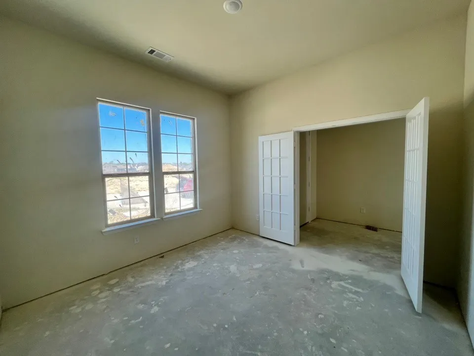 Interior room featuring two large windows, recessed ceiling lighting, and French doors