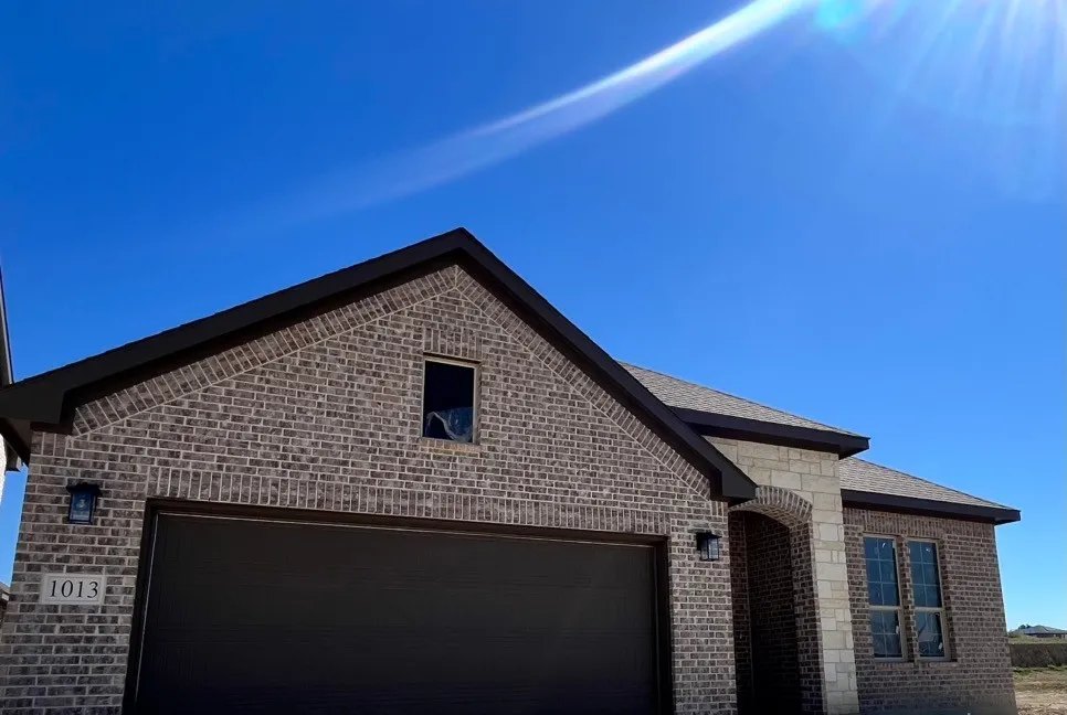 Brick and stone facade with an arched entry