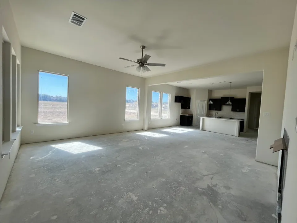 Vaulted ceiling with ceiling fan, recessed lighting, and multiple windows