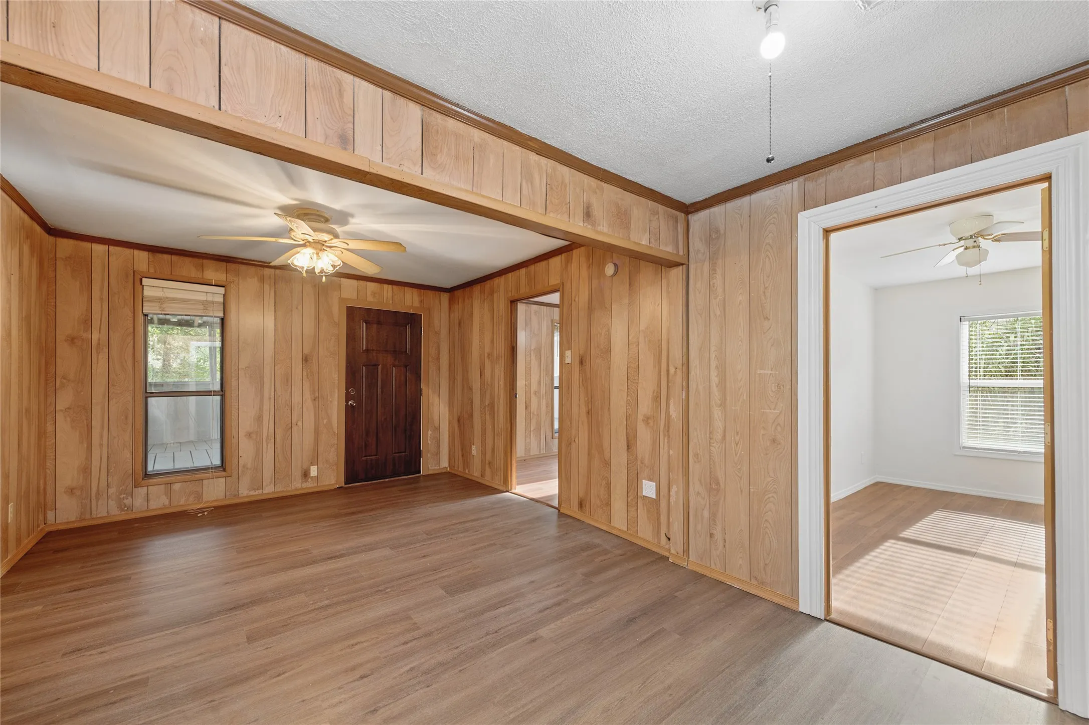 Wood-finish flooring, wood paneling, recessed lighting, ceiling fan