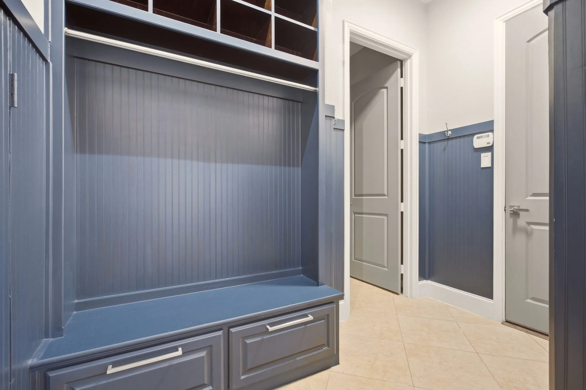 More awesome storage for shoes, coats, bags & sports gear, helping to organize everyday essentials. Adjacent laundry room also has storage cabinets + includes a handy second refrigerator.