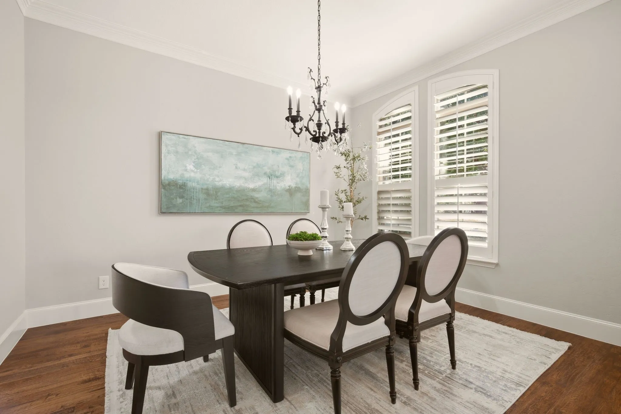For those who love a formal dining room, this one makes a statement off the foyer. Love the chandelier & classic plantation shutters. A refined transitional aesthetic paired with simplified details for a current feel. (Staging Table/chairs not included. Buffet negotiable).