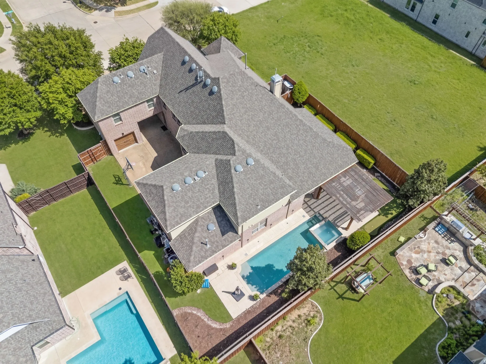 Nearly 5300 sq.ft. on a beautiful corner lot.  Property adjacent to this home is owned by the HOA Shaddock Park. This aerial shot shows the amount of motor court space for vehicles, sport & kid play. Two side yards for kids & pets to play on.