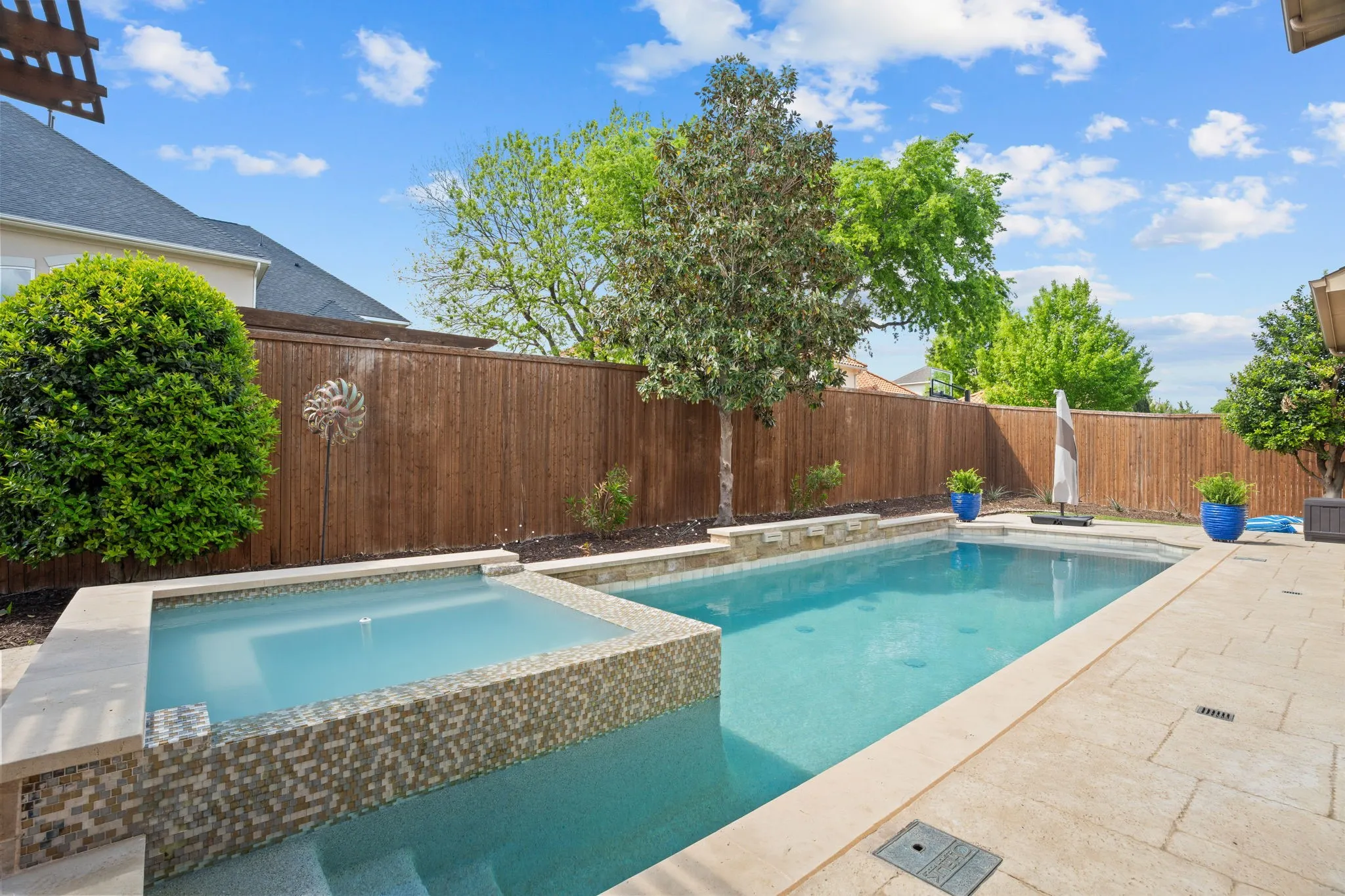 Sunshine, splashes & smiles! This backyard pool & spa -- recently refreshed -- sparkling & ready for year-long fun with family. You'll love the serenity of this top-of-the-line chlorine swimming pool-spa---featuring waterfalls, a spa bubbler + newly renovated pebble tech surface with glass tile accents surrounding the hand-cut stone pavered patio. Tranquil landscape lighting + more hearty Texas landscaping add to the overall ambiance!