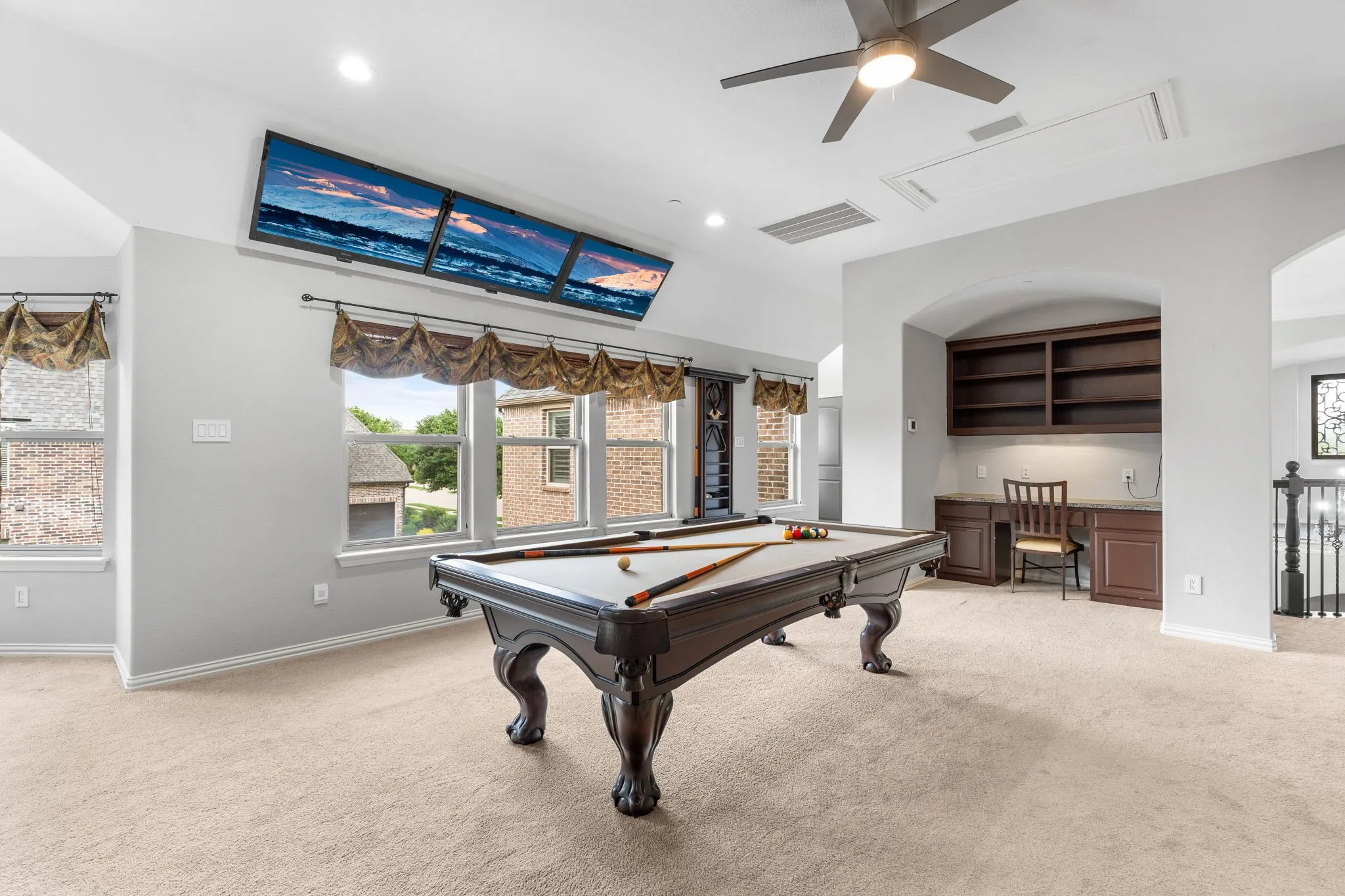 The ultimate for entertaining---this gigantic, open gameroom includes mounted TVs for watching your favorite sporting events at the same time. To the left...a media room + bedroom 3 & a full bath. To the right...a gameroom wetbar + bedrooms 4 & 5 with a shared bath. Access the gameroom from one of two staircases.
