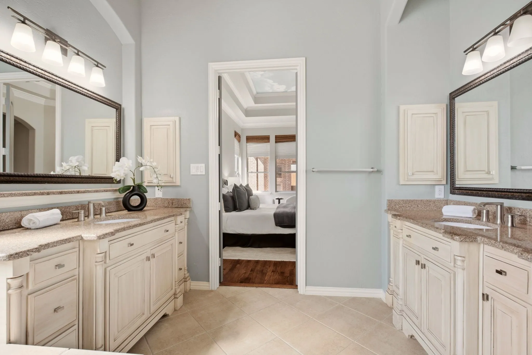 Zen-like primary bath offers a luxurious retreat, featuring a jetted tub, huge walk-in closet, built-in jewelry cabinet, framed mirrors & granite countertops.
