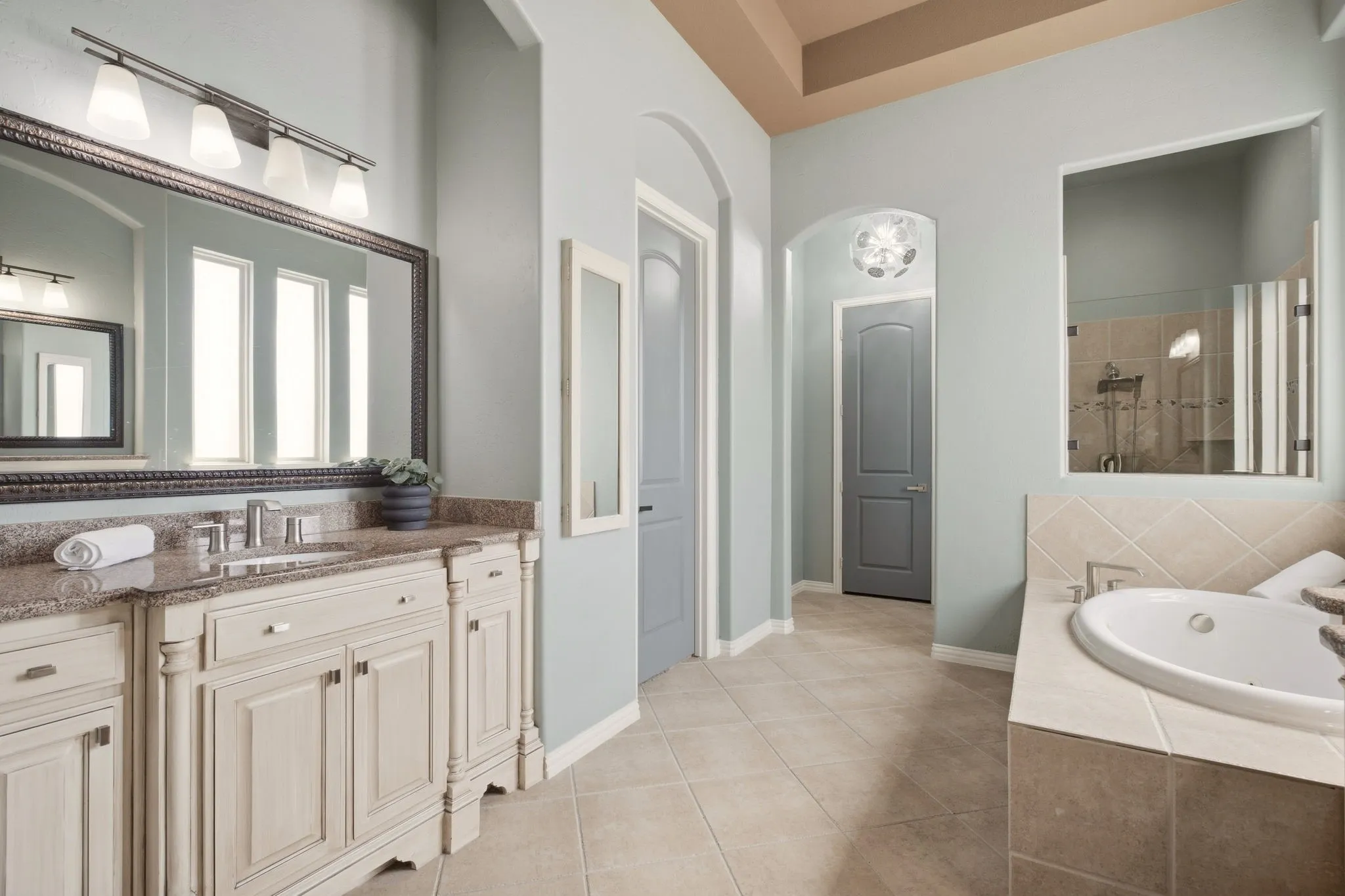 Dual vanities offer a good amount of storage. Spacious walk-in primary closet.