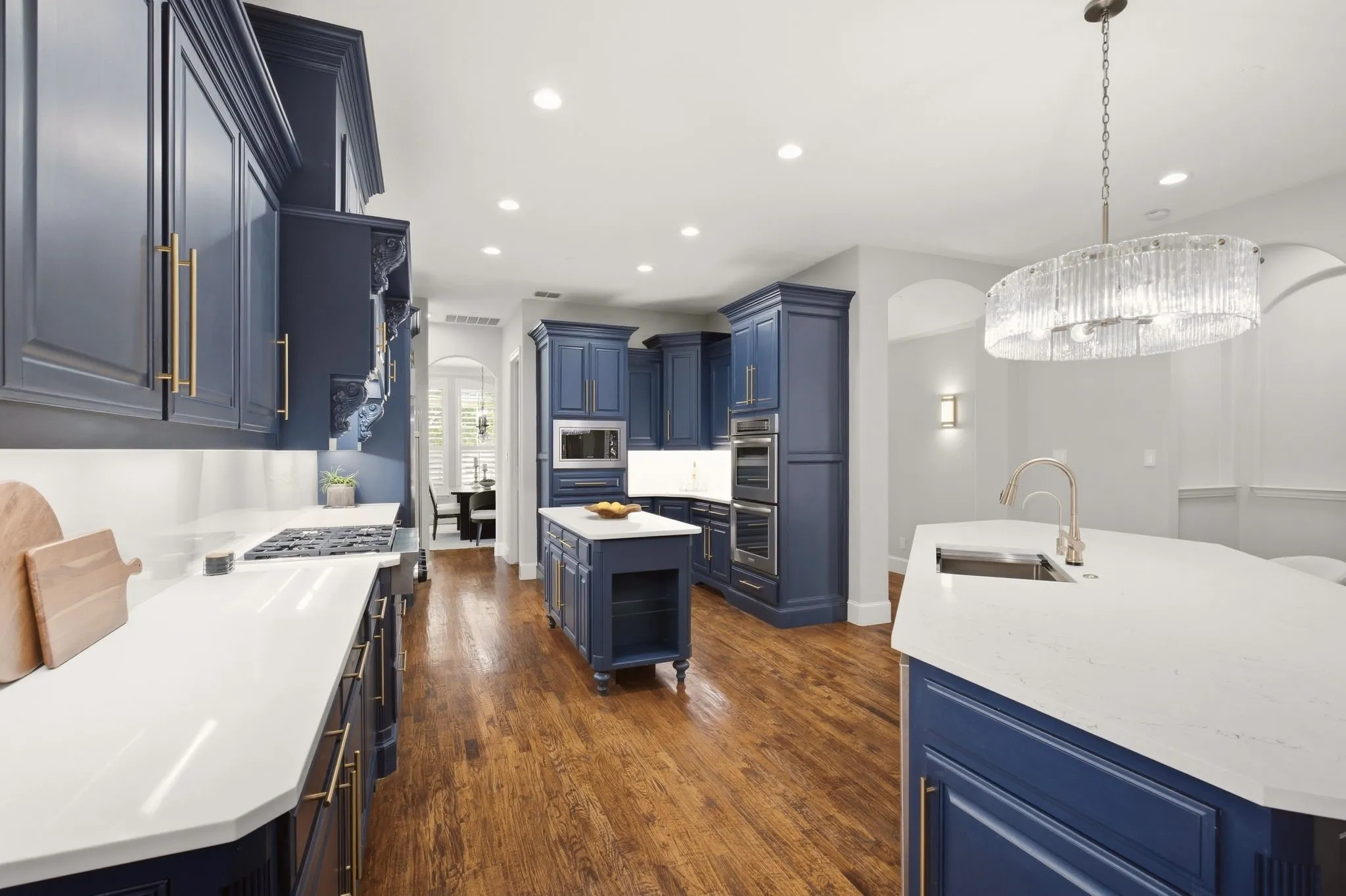 For those who put their kitchen first...this is the one! Extensive cabinet storage, a deep walk-in pantry & loads of counter space. Notable: NO outlets on the quartz backsplash...they're tucked under the upper cabinets!! Clean lines & so convenient to maximize your space.