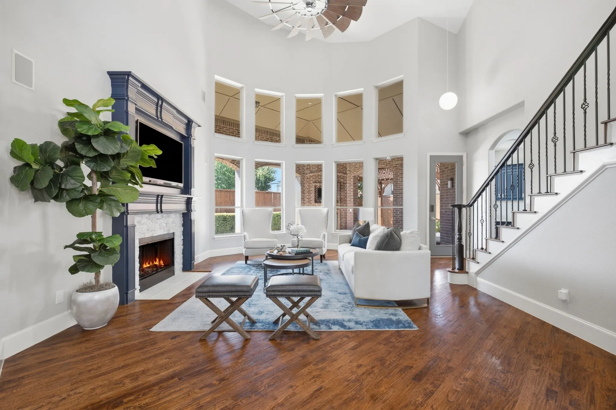 Favorite features of the sellers: gleaming hand scraped hardwood floors, the two-story windows, the beautiful mantle surrounding the cozy fireplace, views to the outdoor living space.