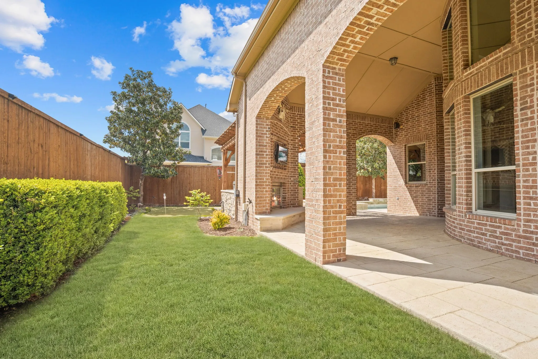 One of two side yards for kids & pets to play. Note the second seating area toward the right of the patio.