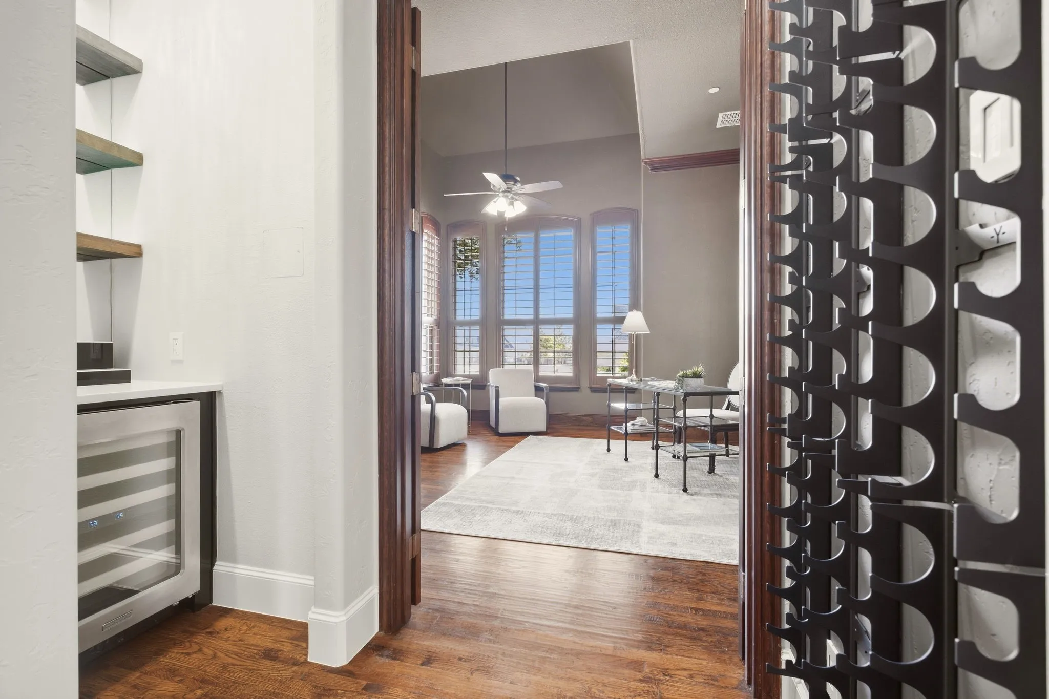 Two looks for this gorgeous dry bar custom designed by the seller with a quartz countertop, custom lighting & includes the handy beverage refrigerator. The sellers added the wine rack wall adjacent to the bar...just bring your wine collection!