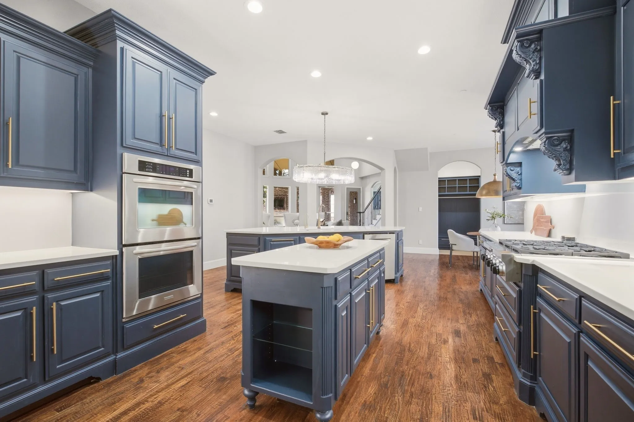 A sneak peek at the recently remodeled kitchen for the serious gourmet in the family! Refreshed quartz countertops + coordinated backsplash with "no show" electric outlets! Love the dramatic blue cabinets, stainless appliances including a Sub Zero refrigerator & gold hardware.