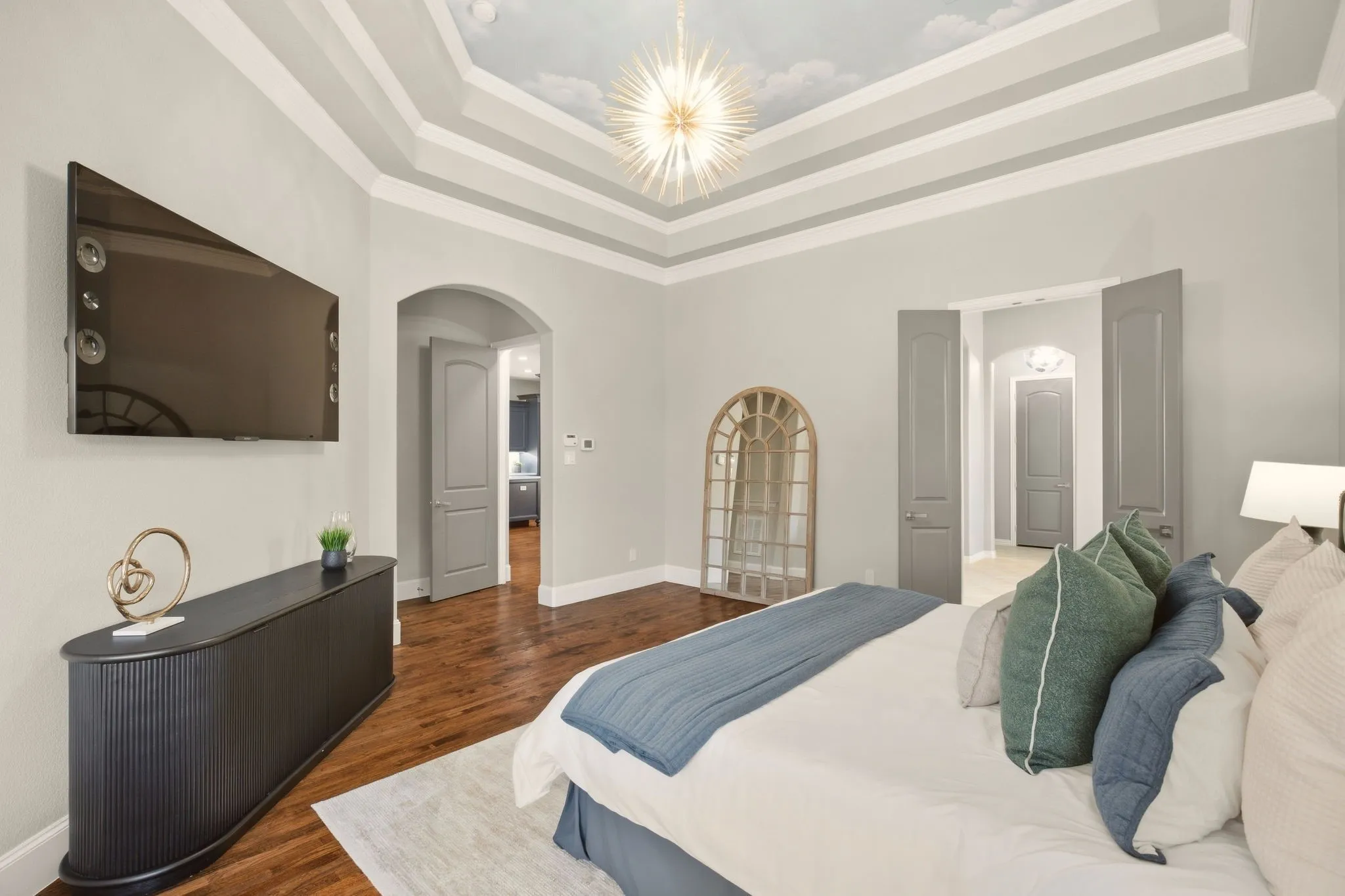 Notable: the cloud mural in the tray ceiling & the art deco light fixture set the stage for an inviting bedroom suite.