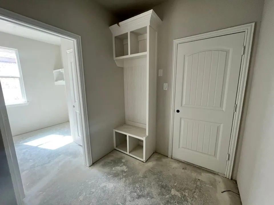 Built-in storage bench with overhead shelving and beadboard detailing