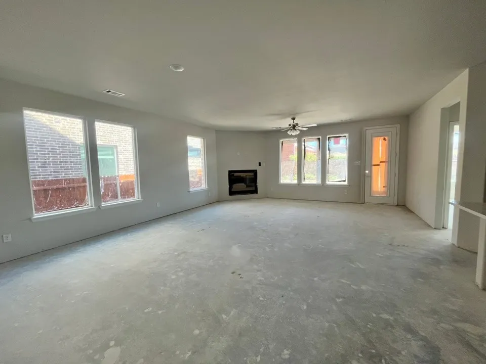 Spacious interior with multiple windows, recessed lighting, and a ceiling fan