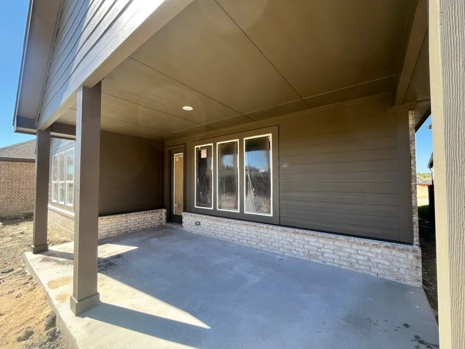 Covered patio with recessed lighting, concrete flooring, and a brick veneer foundation