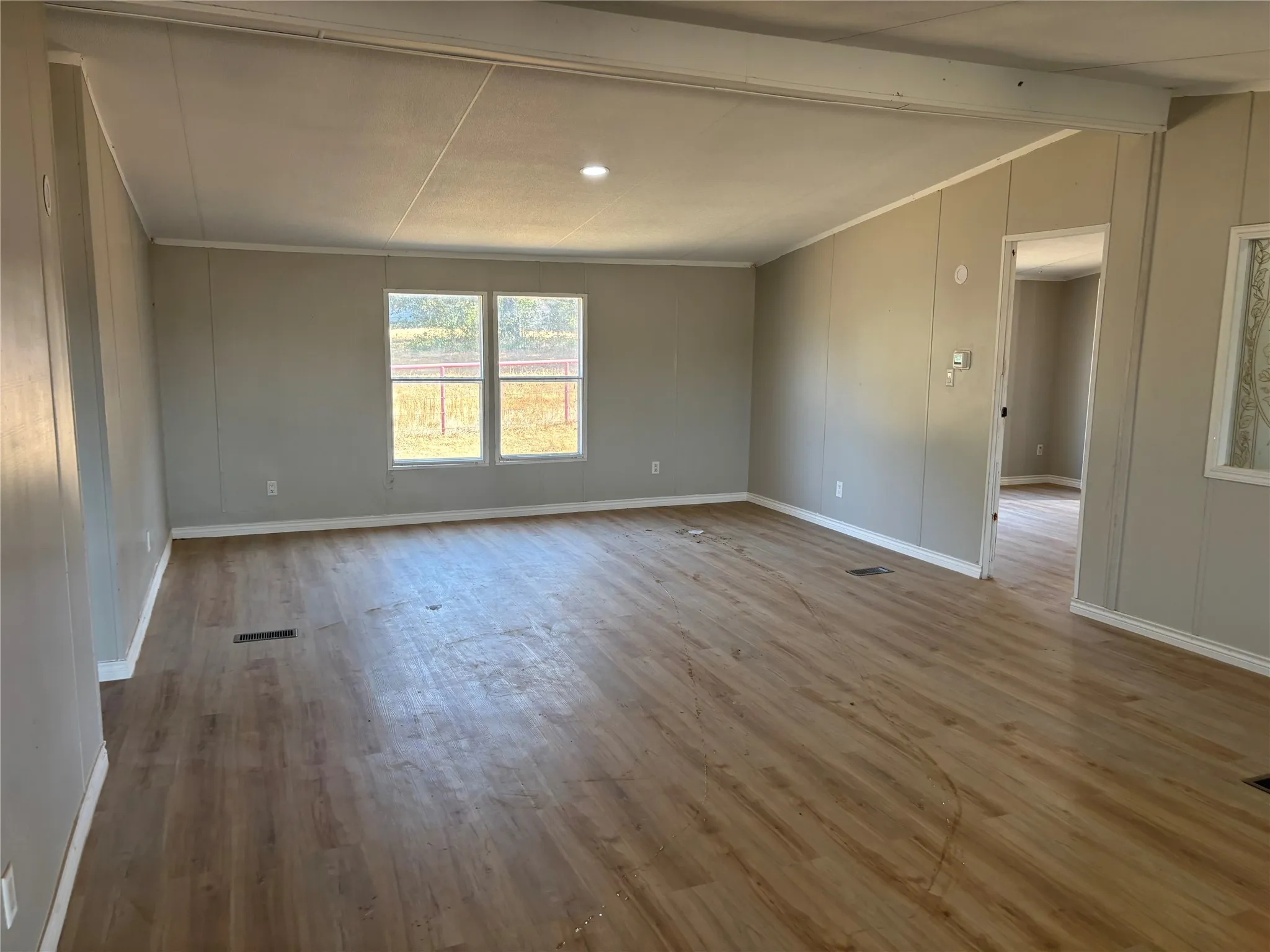 Open-concept living area featuring wood-finish flooring, recessed lighting, and neutral wall tones
