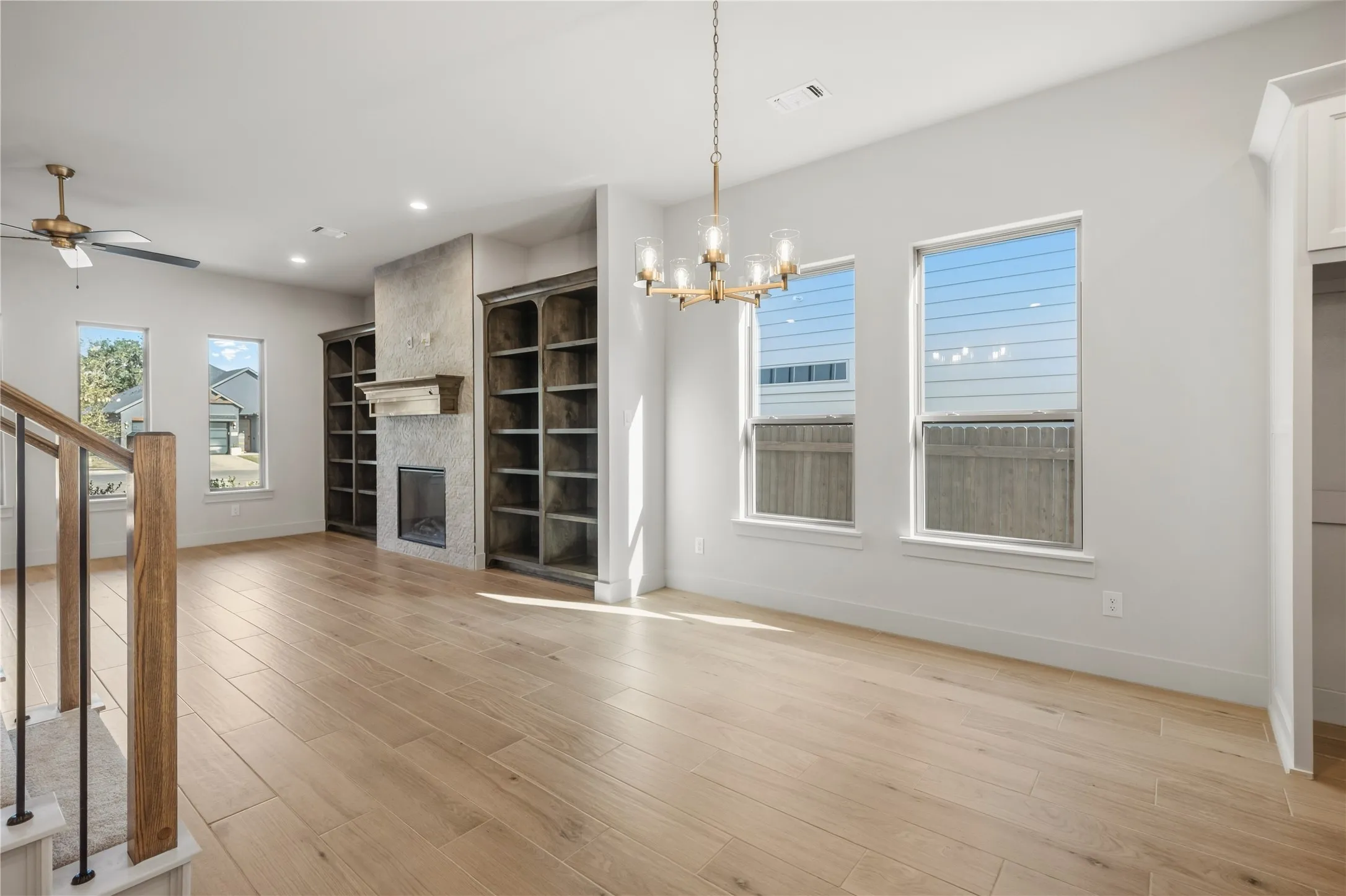 Light wood-finish flooring complemented by a modern chandelier
