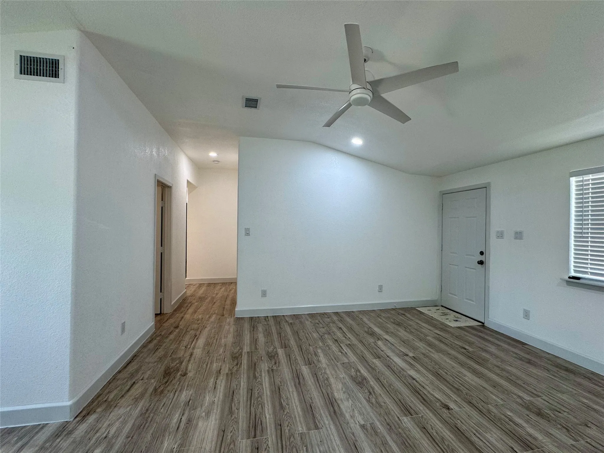 Unfurnished living room featuring ceiling fan, wood finished floors, and recessed lighting