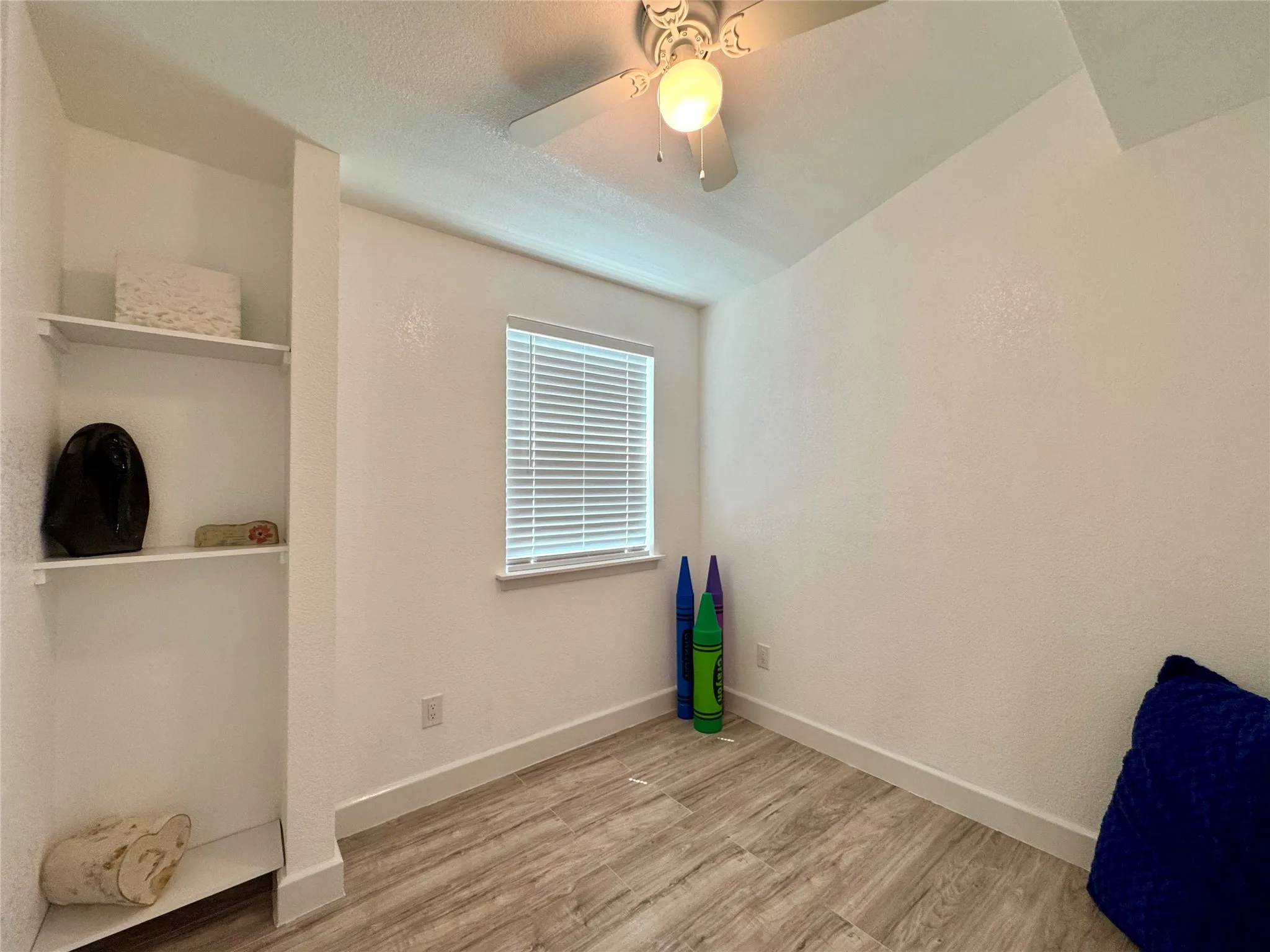 Unfurnished bedroom featuring wood finished floors and ceiling fan