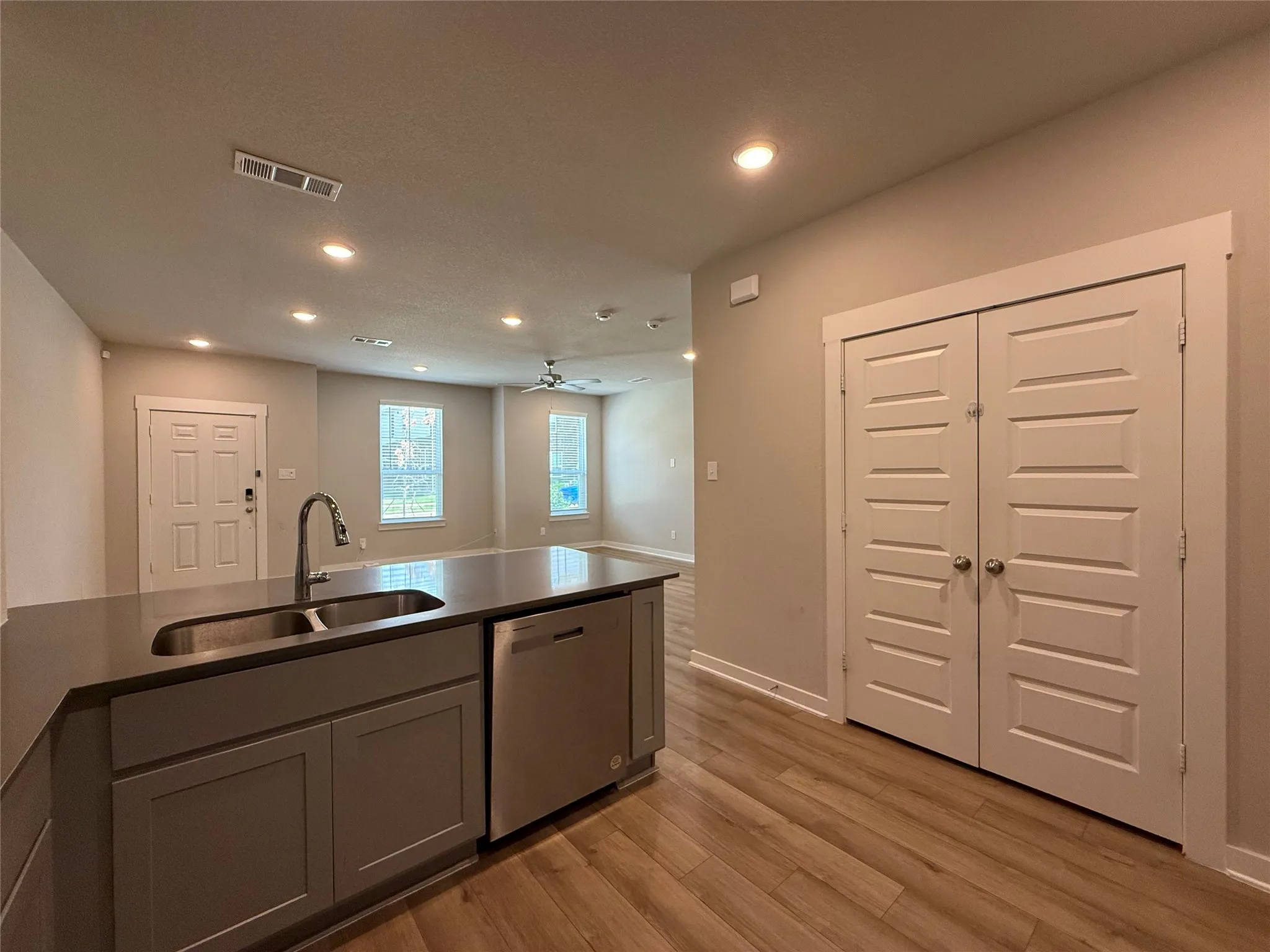 Kitchen island with a double basin sink and stainless steel dishwasher