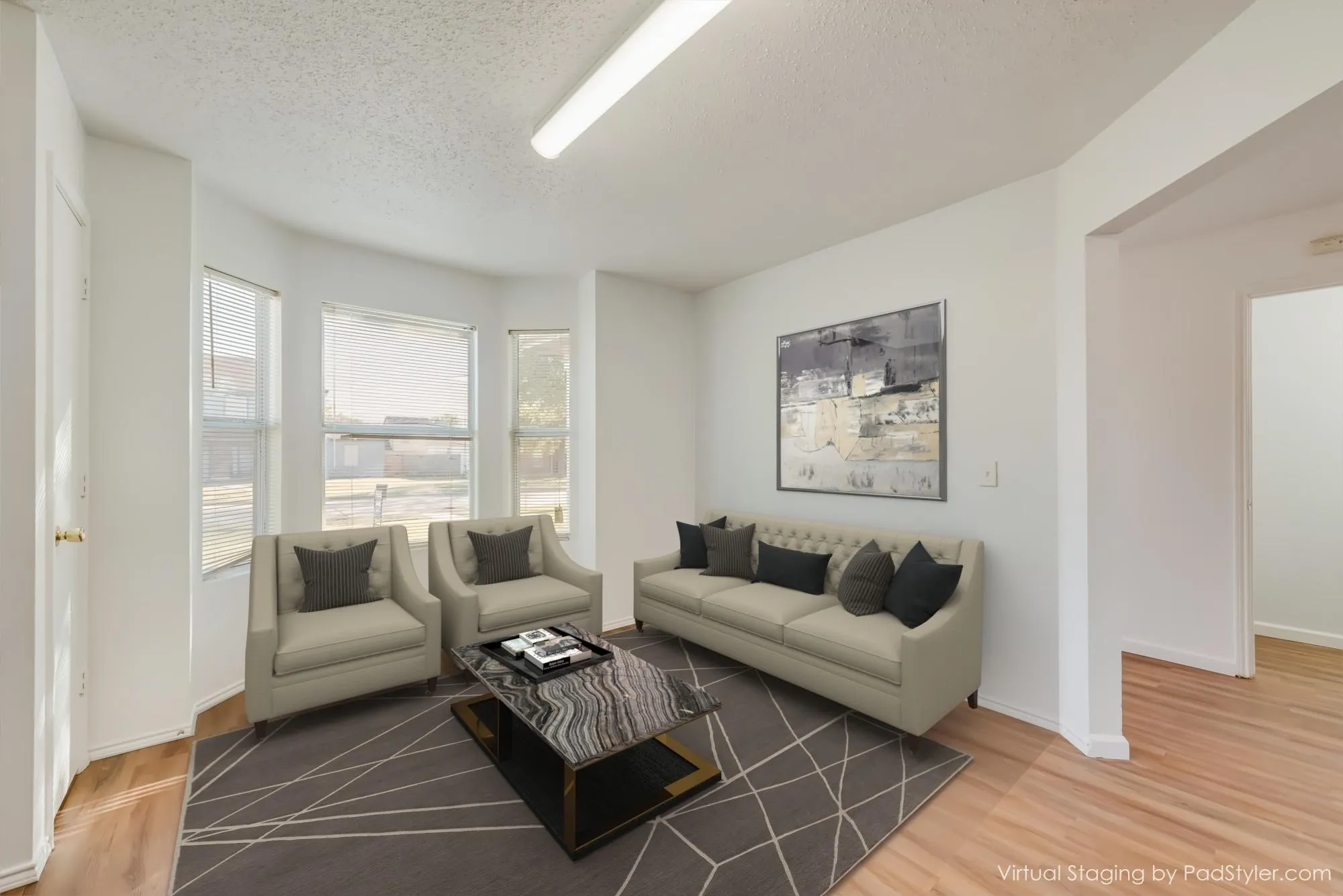 Bay window with multiple panes, wood-finish flooring, white painted walls, and overhead fluorescent lighting
