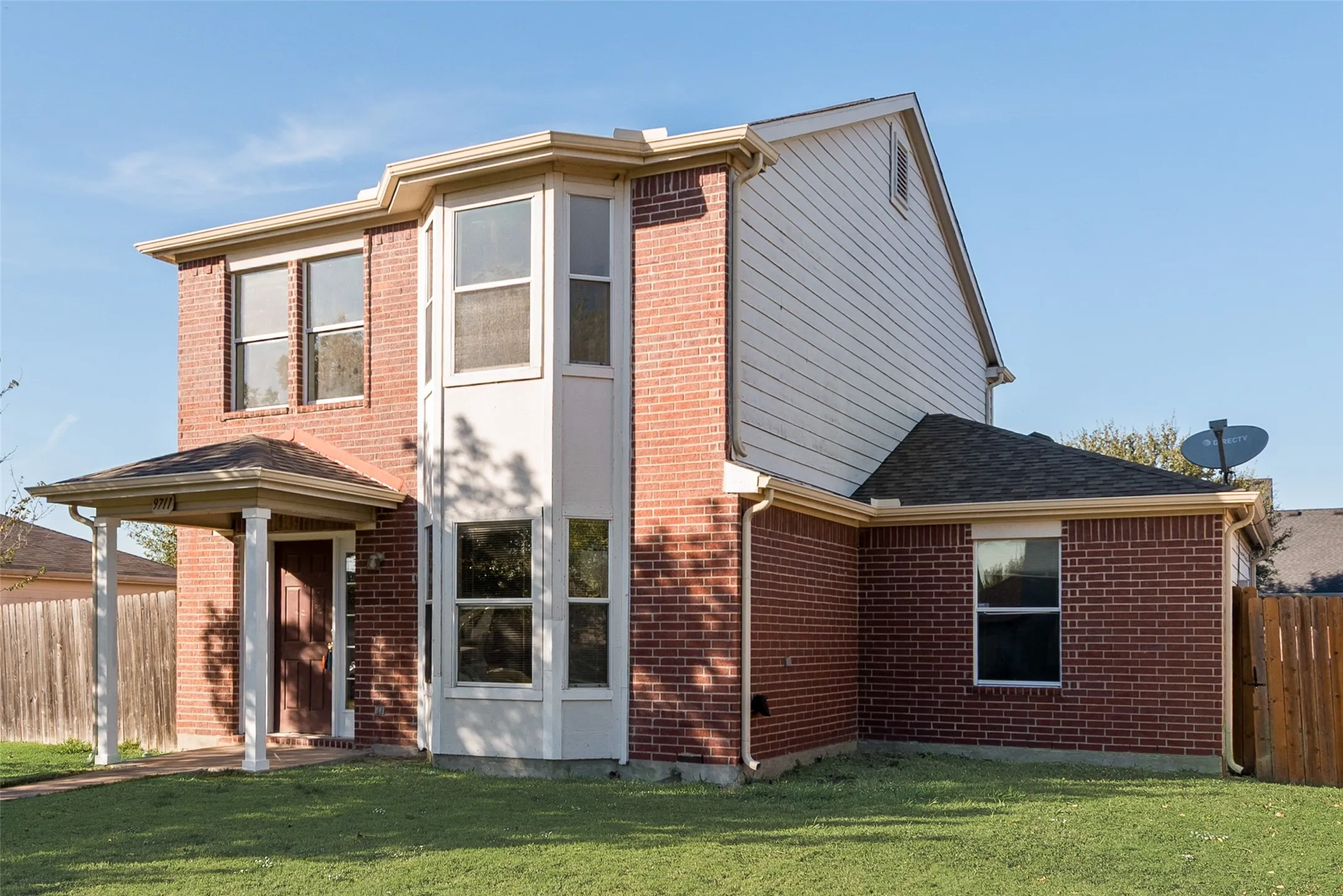 Red brick exterior with white siding accents