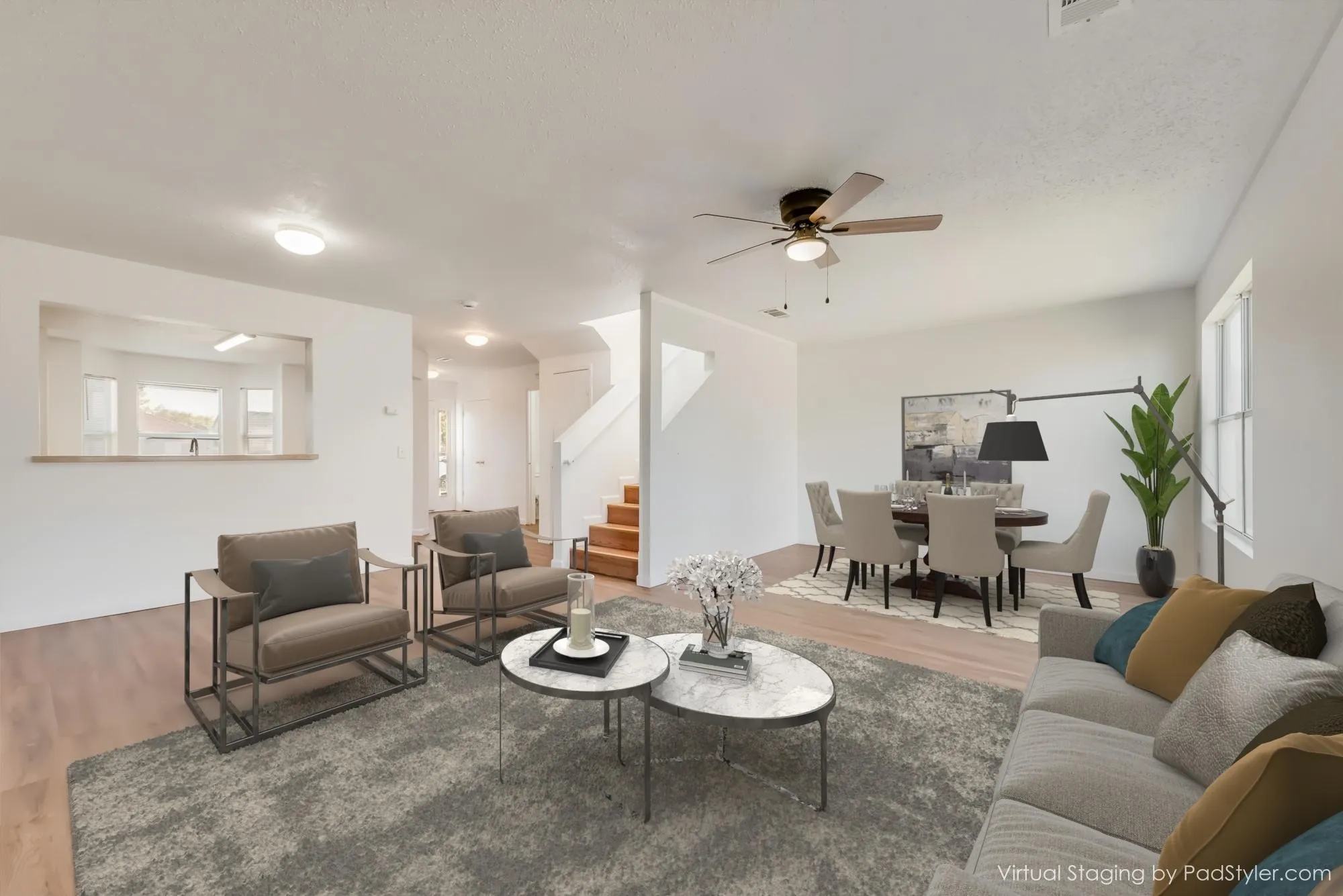 Open-concept living area with wood-finish flooring, recessed lighting, and a ceiling fan