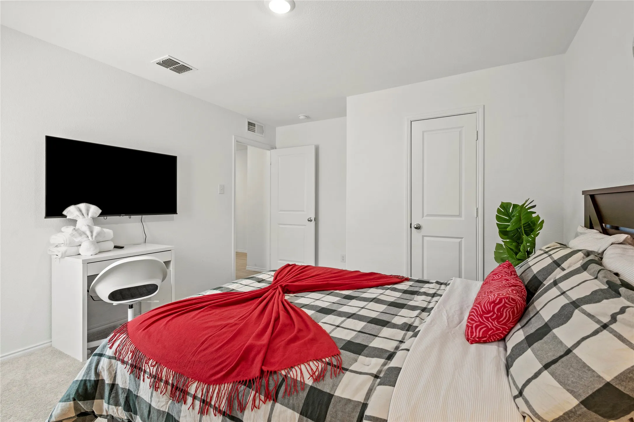 Recessed lighting, wood-finish headboard, and solid core doors