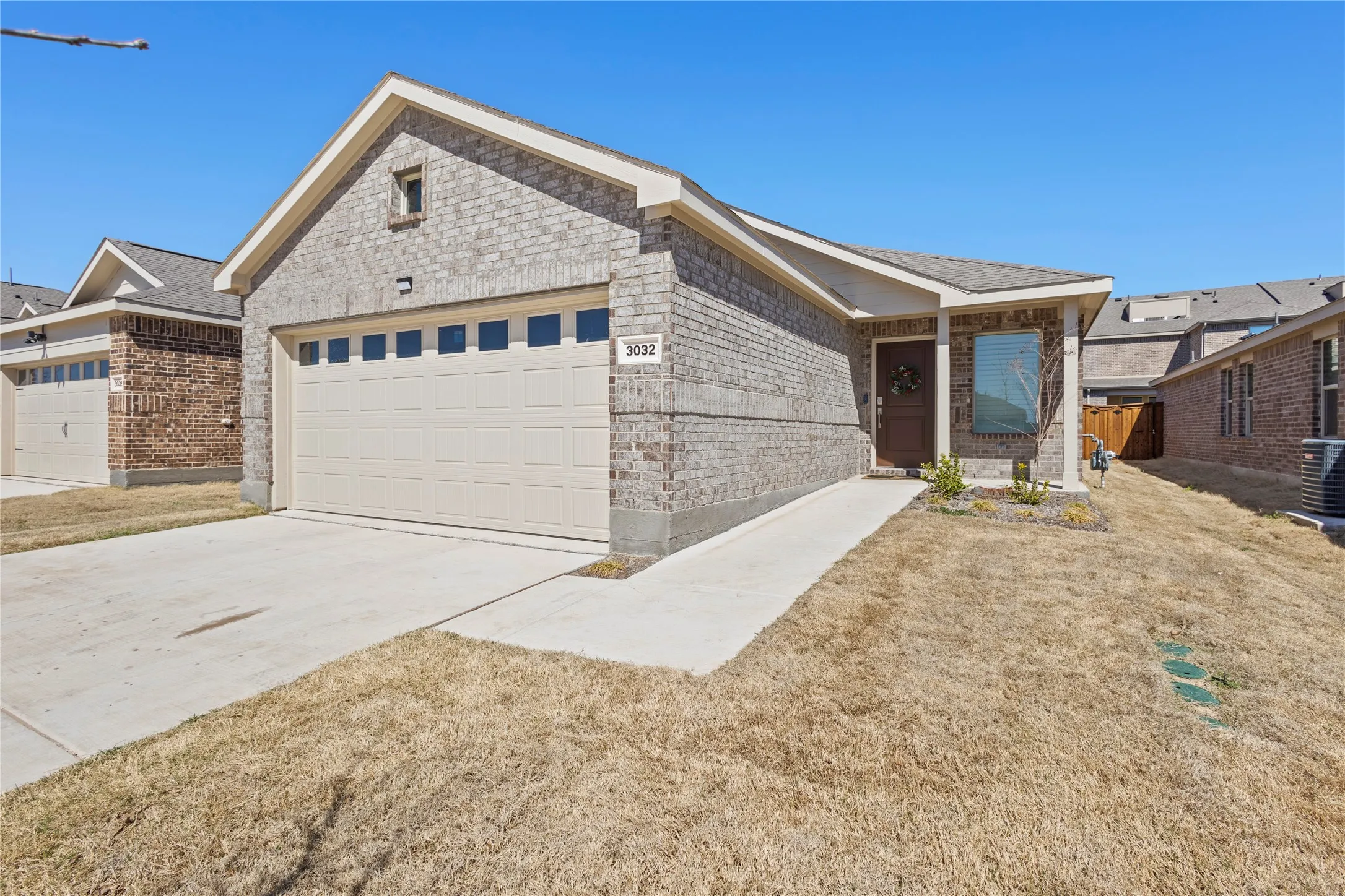 Brick exterior with a single-car garage and a concrete driveway