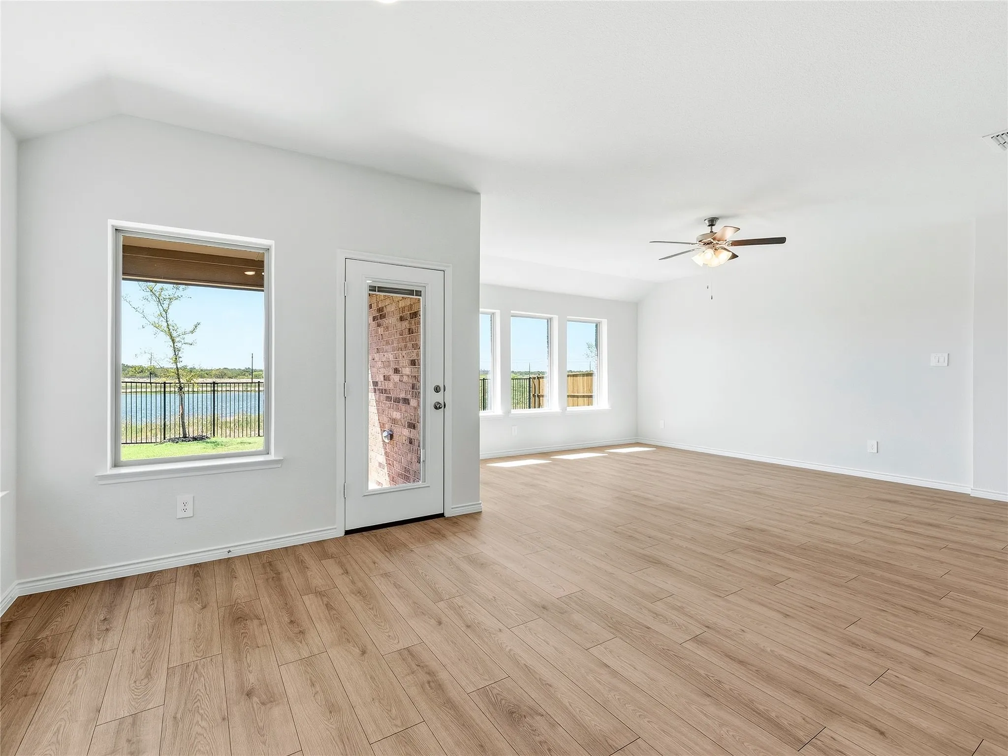 Scenic view of the lake framed by multiple windows, offering ample natural light and a peaceful atmosphere.