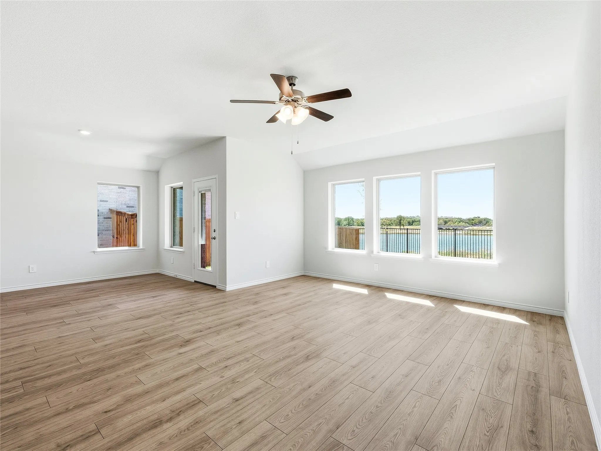 Lake view throughout the open concept living areas, ceiling fan with integrated lighting, recessed lighting, windows will have blinds for added privacy