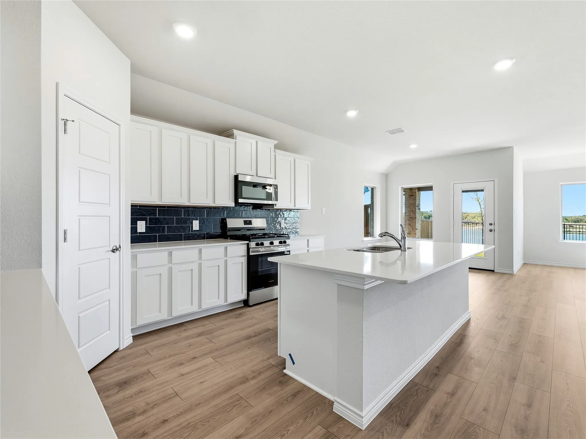 Modern kitchen with center island and breakfast bar seating.