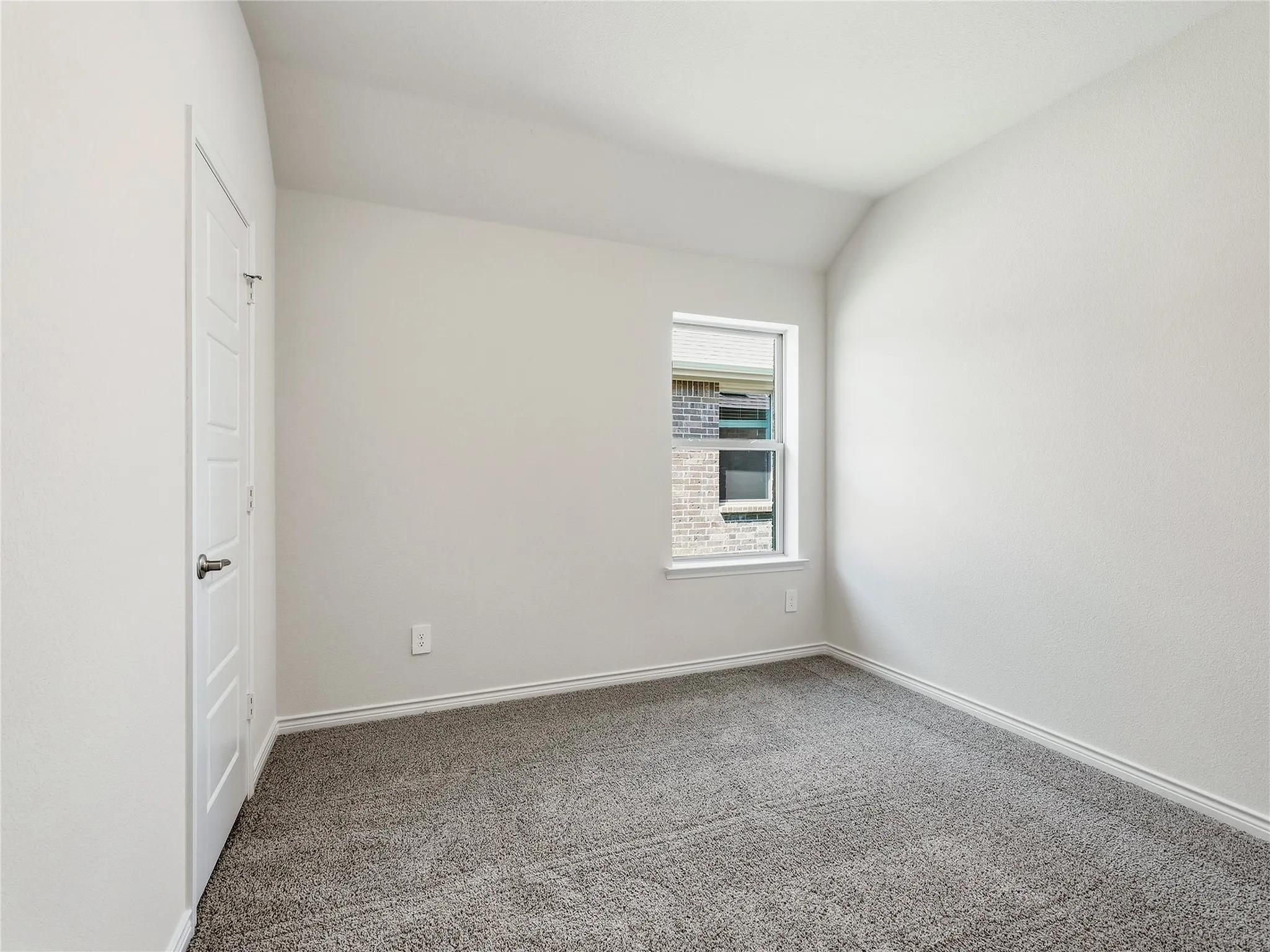 #2 Neutral white walls, gray carpeting, and a single window with white trim