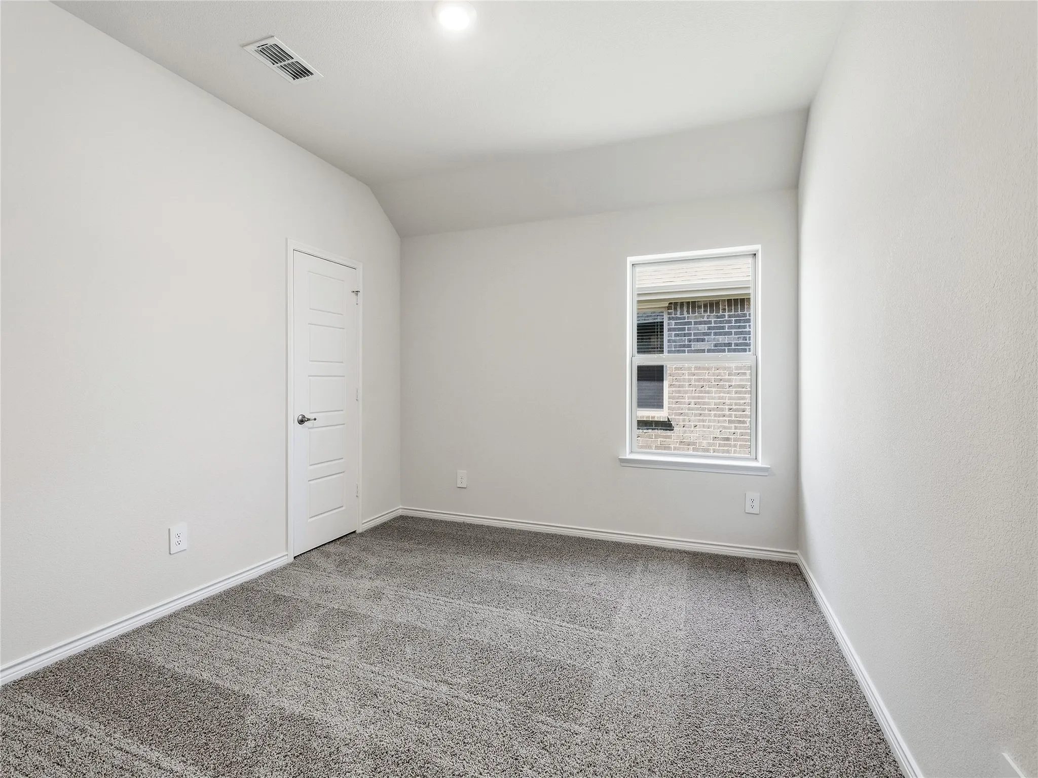 #2 Neutral wall color, grey carpet flooring, single window, white trim, and a white interior door